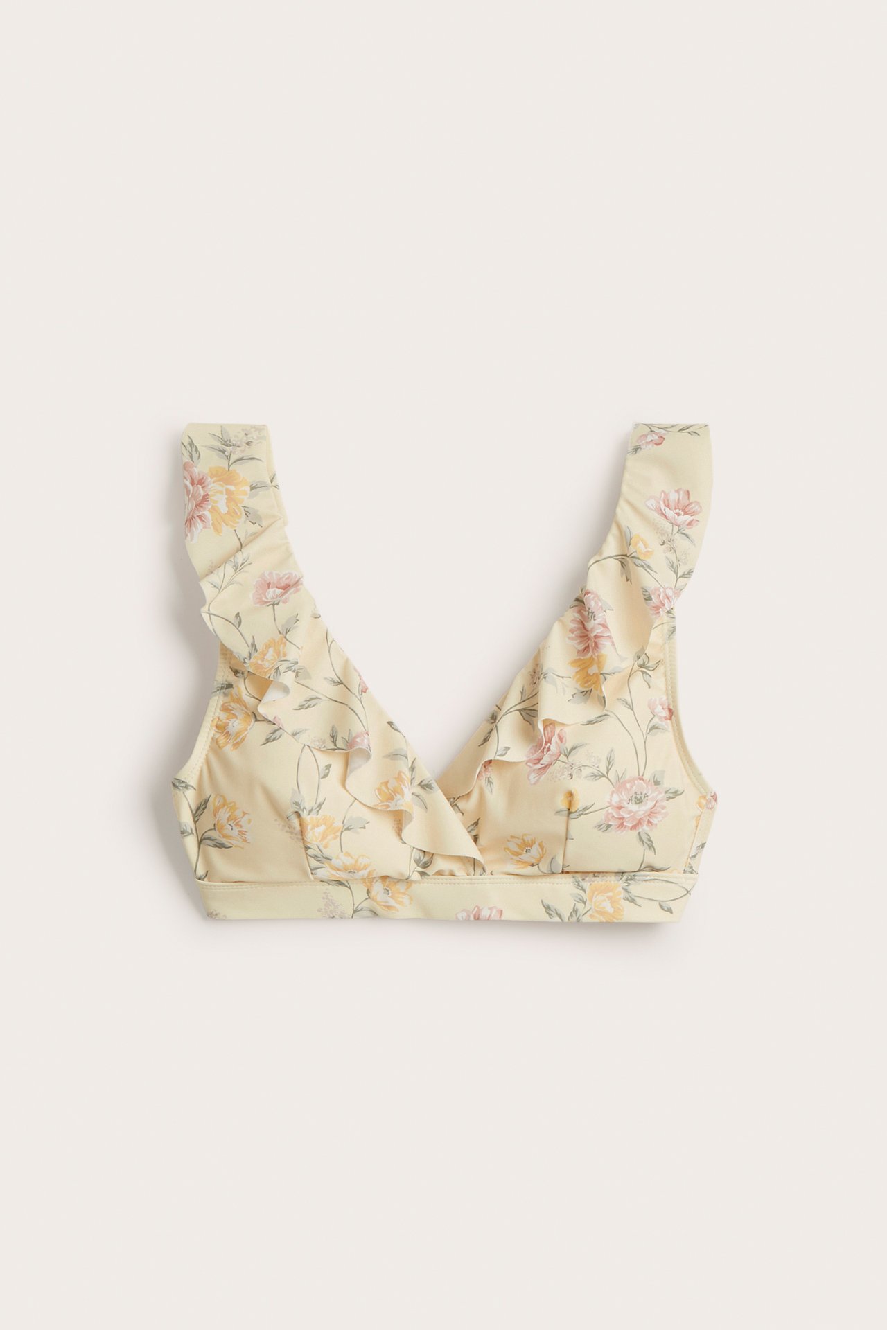 Vorderansicht eines hellgelben floralen Bikinioberteils mit Rüschen, verstellbaren Trägern und Rückenverschluss.