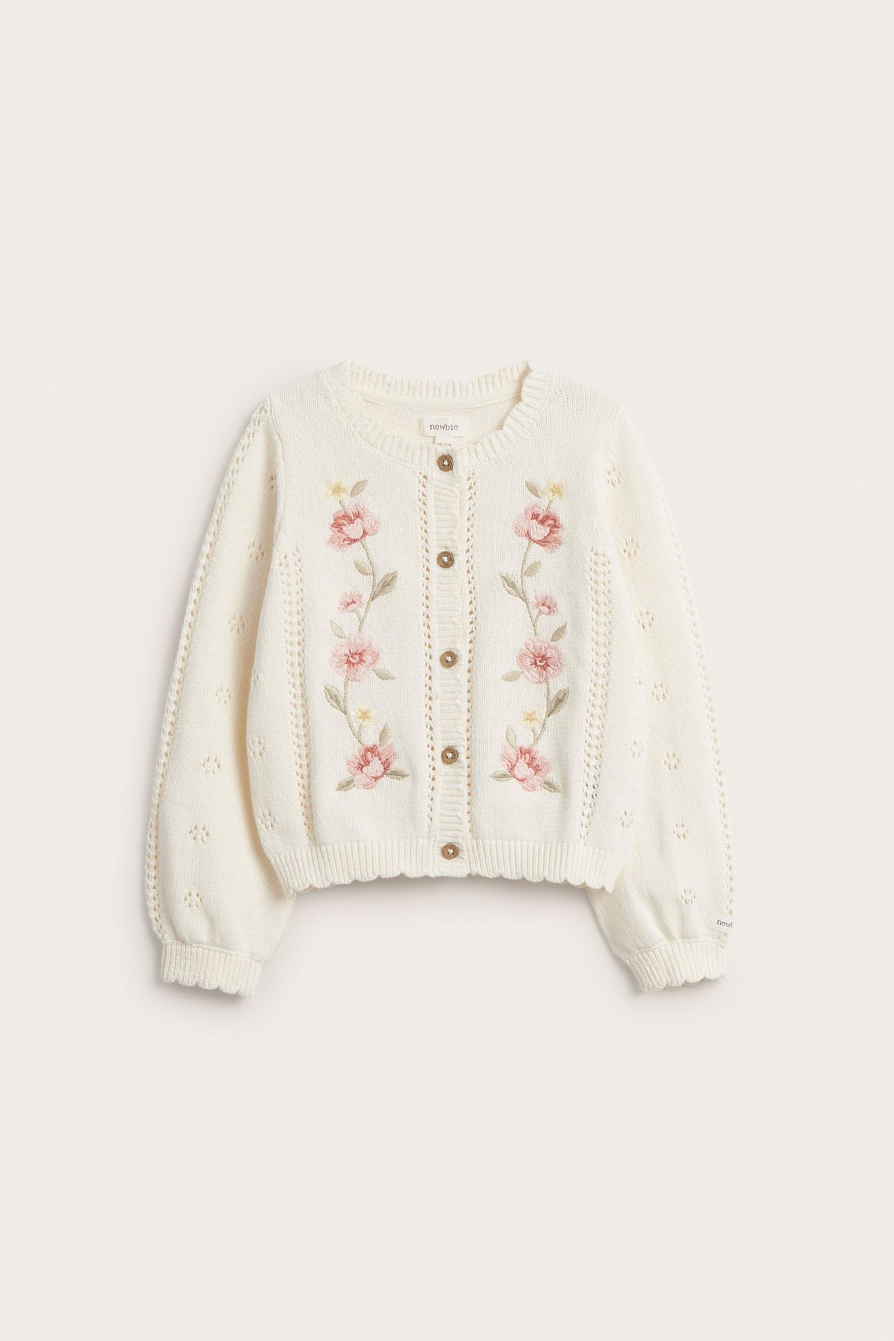 Front view of an off-white kid's cotton cardigan with floral embroidery, pointelle sleeves, and front buttons.
