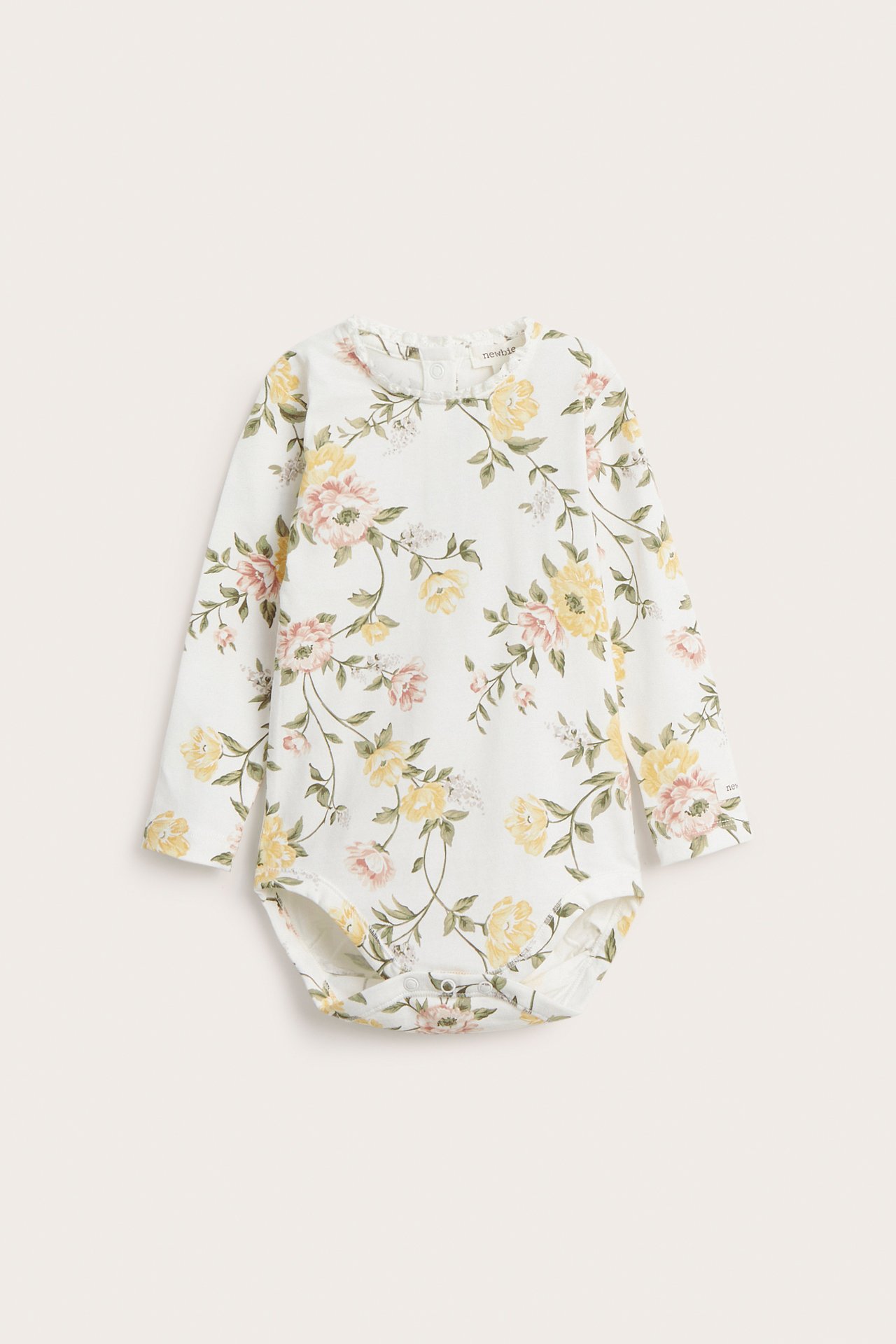 Front view of an off-white baby long-sleeved jersey bodysuit with a floral pattern and lace trim.