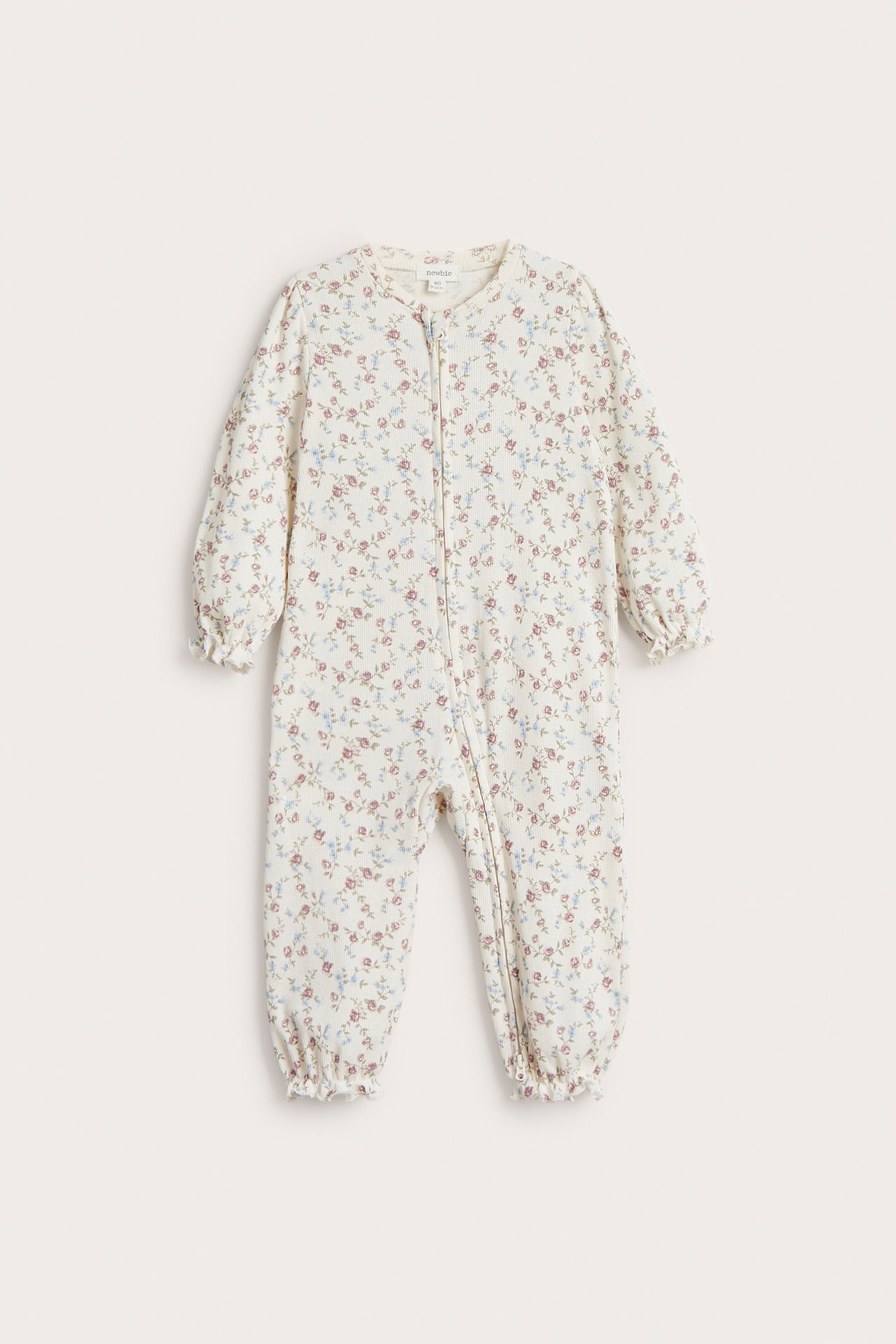 Front view of an off-white baby's floral ribbed cotton pajama with a two-way zipper.