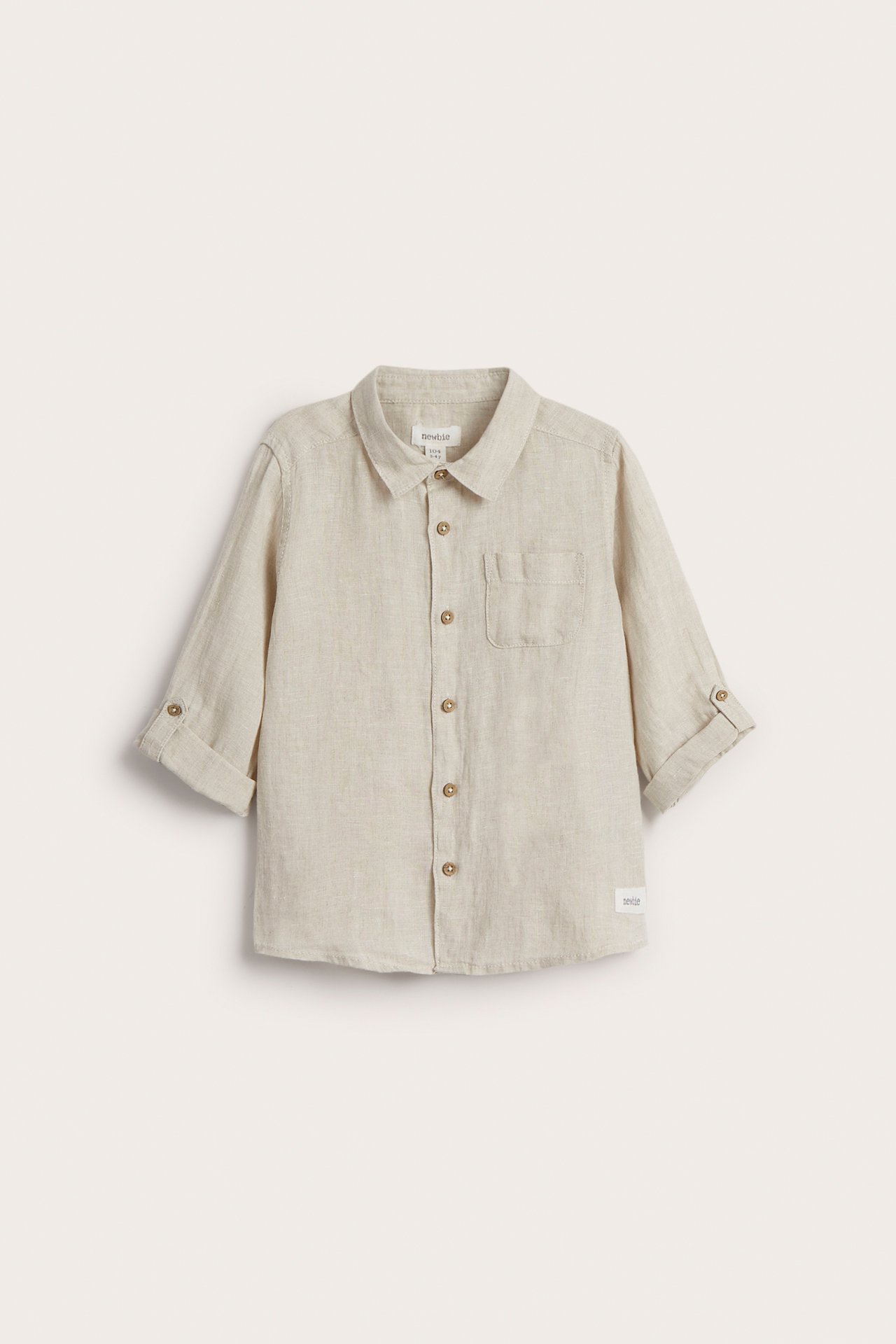 Front view of a kid's light beige linen shirt with rolled-up sleeves, front buttons, and a chest pocket.