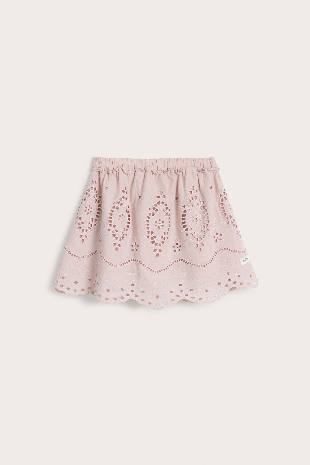 Front view of a pink kid's embroidered cotton skirt with an elasticated waist and scalloped hem.