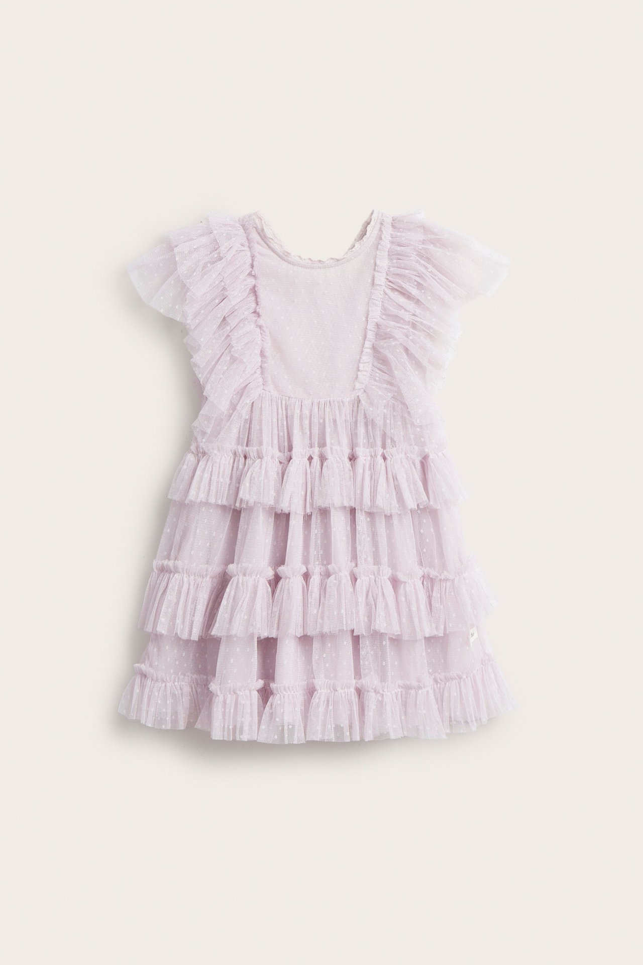Front view of a kid's light lilac mesh dress with polka dots, tiered ruffles, and shoulder ruffles.