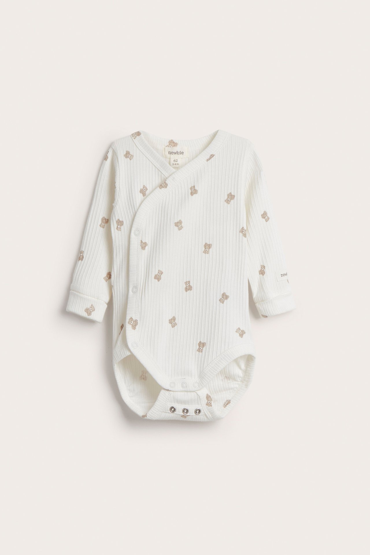 Front view: Offwhite ribbed baby bodysuit, long sleeves, teddy pattern, wrap-around, snap buttons.