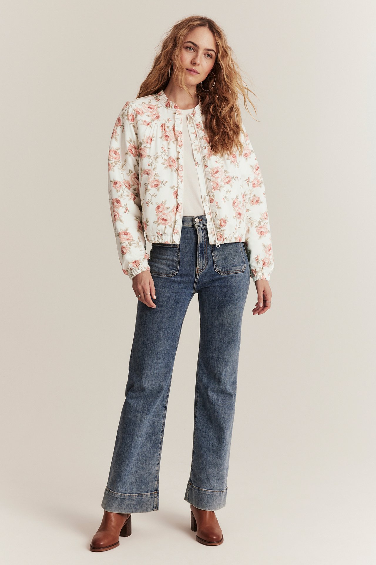 Printed bomber jacket for woman in offwhite with small ruffle collar, zipper, and two front pockets.