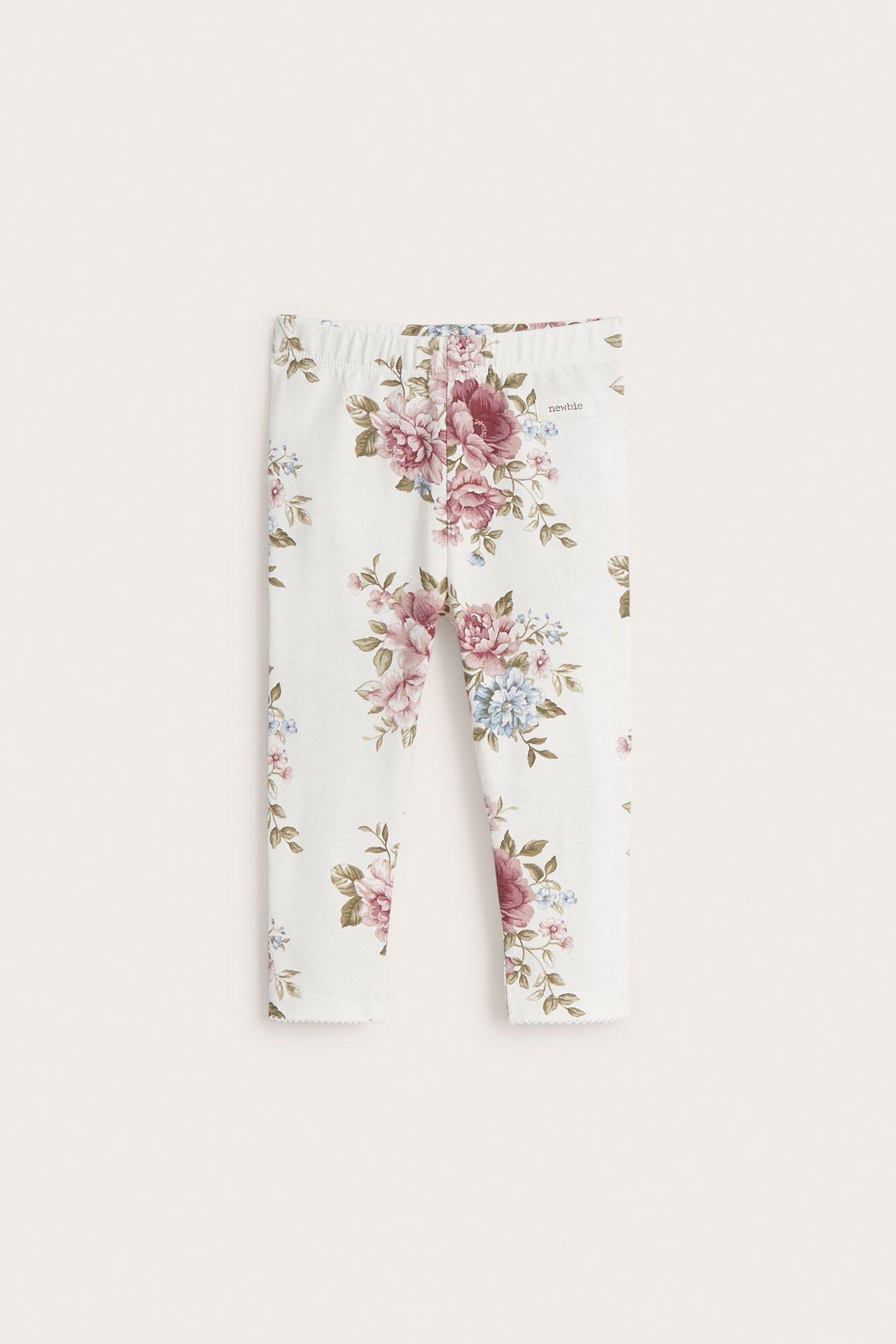 Front view of off-white baby cotton jersey leggings with a pink and blue floral print and elastic waist.