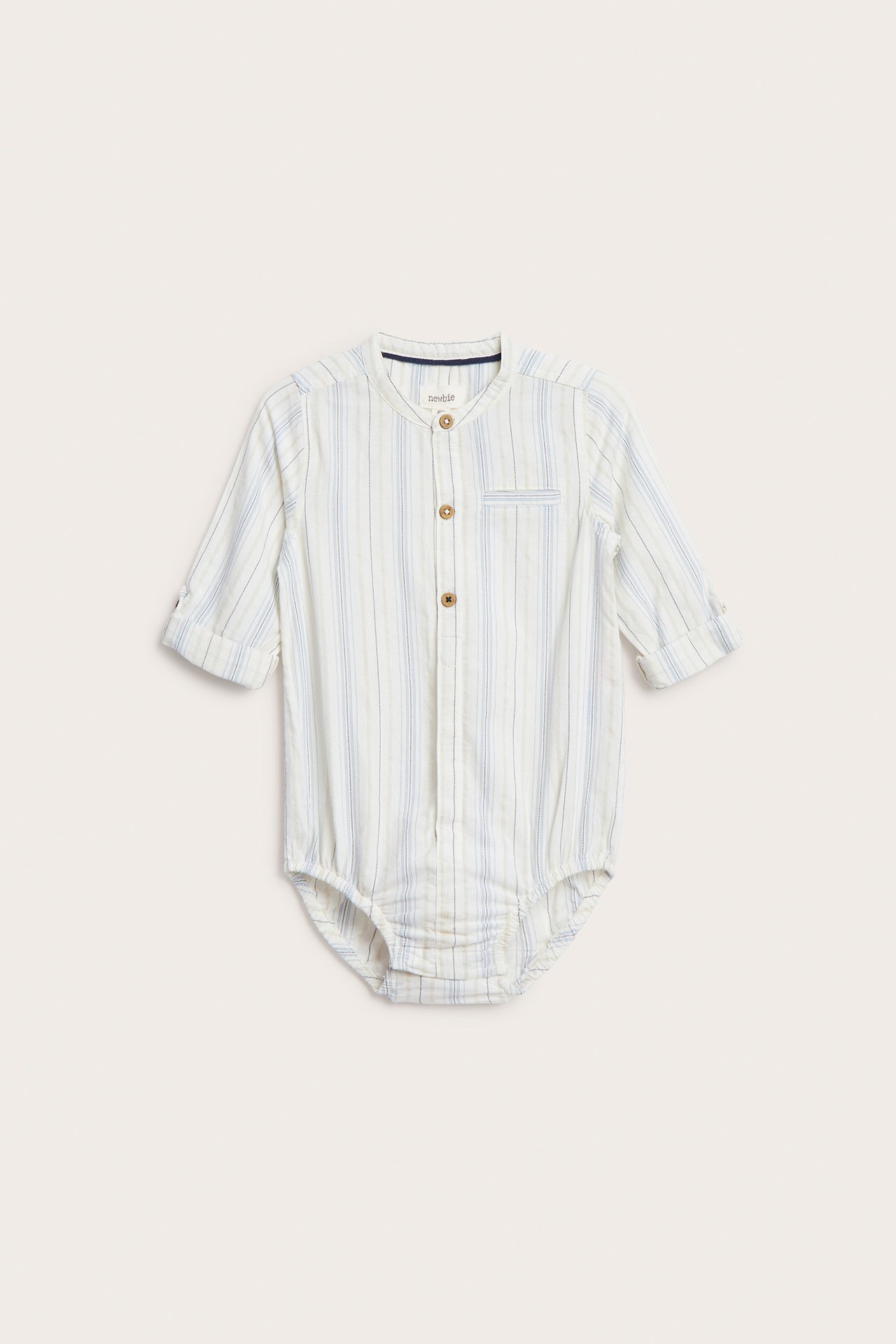 Front view of a baby's off-white striped organic cotton shirt-bodysuit with mandarin collar and rolled-up sleeves.