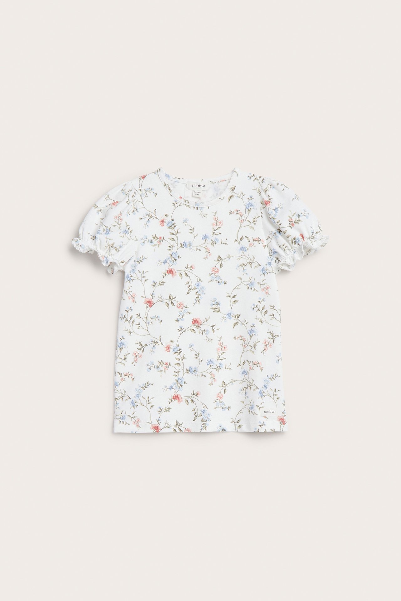 Front view of an off-white floral short-sleeved top with puff sleeves and picot trim.