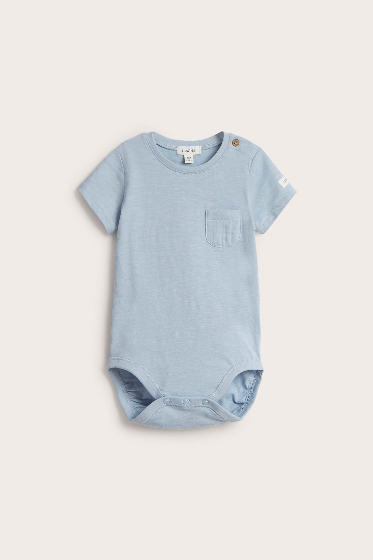 Front view of a light blue baby short-sleeved cotton bodysuit with a chest pocket and shoulder snap.