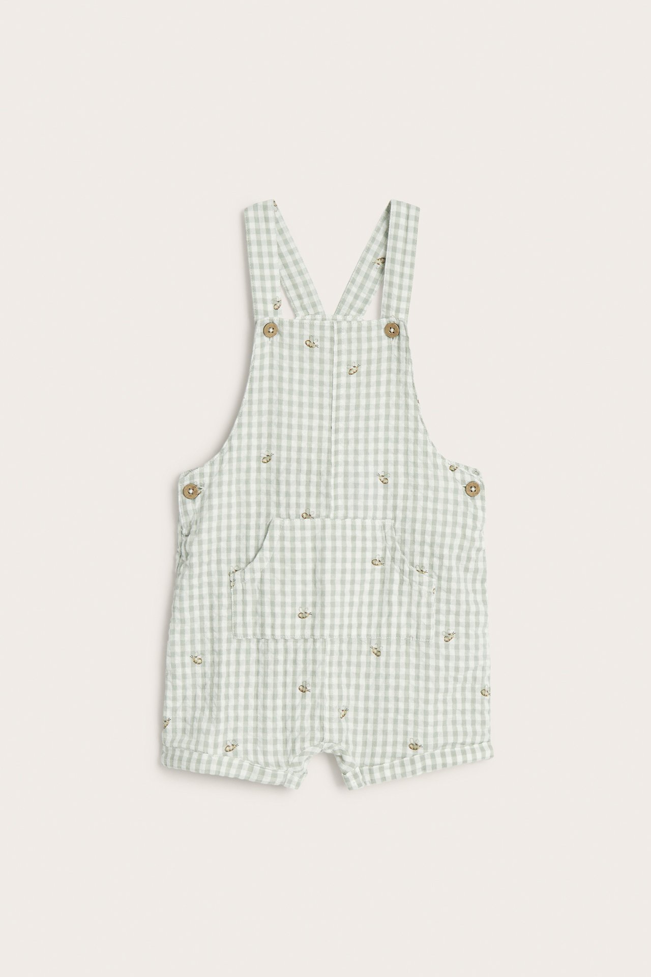 Vorderansicht: Baby-Latzshorts aus hellgrüner karierter Baumwolle mit Tierstickerei und Knöpfen.