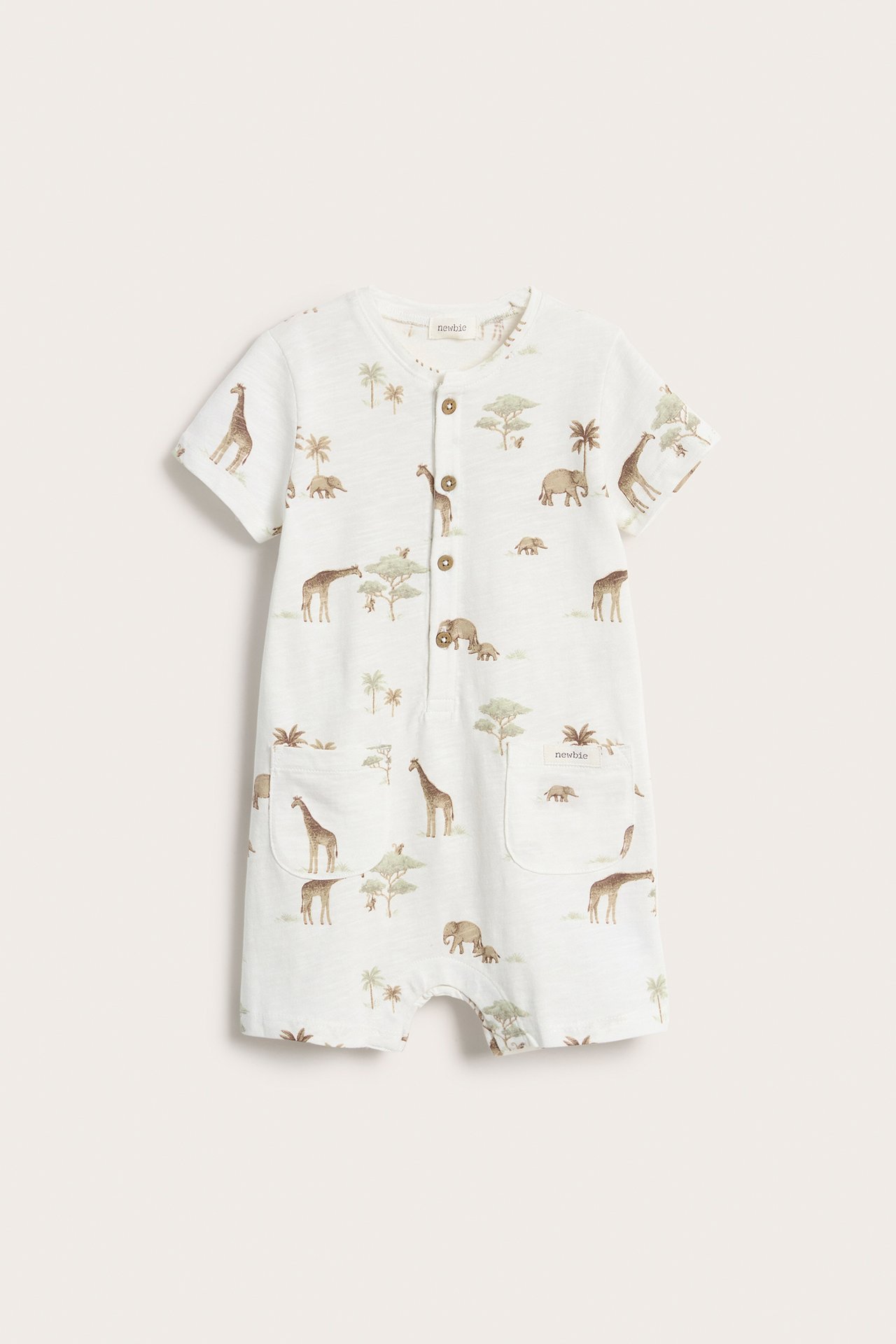 Front view: Off-white baby playsuit with animal print, short sleeves, front buttons, and two pockets.