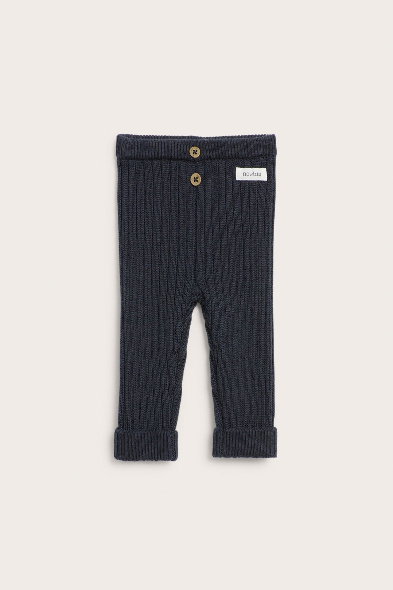 Front view of dark blue ribbed wool baby leggings with two decorative buttons at the waist.