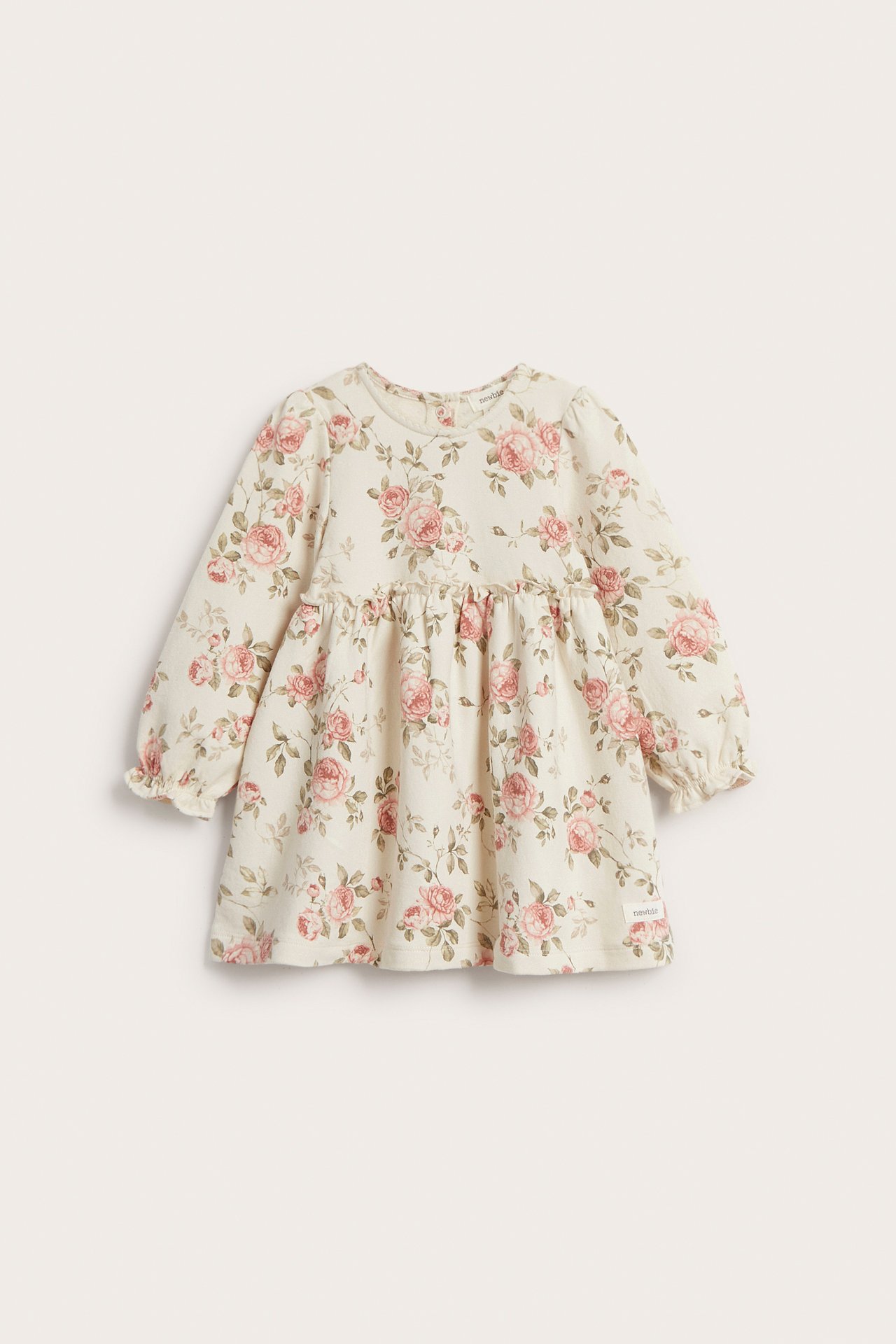 Front view of a light beige baby's floral jersey dress with long puff sleeves and a gathered waist.