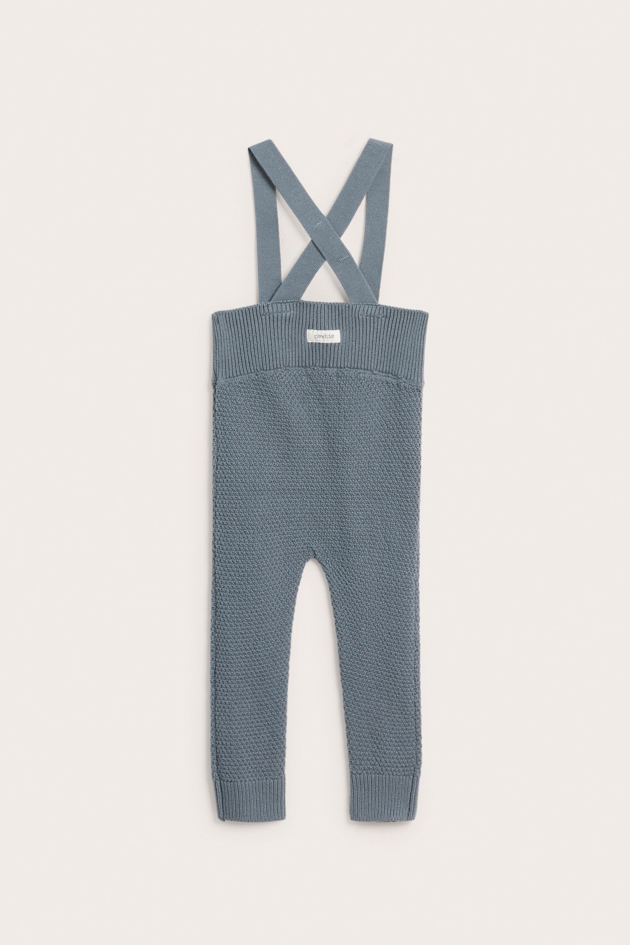 Front view of blue textured knit baby dungarees with adjustable cross-back straps and ribbed cuffs.