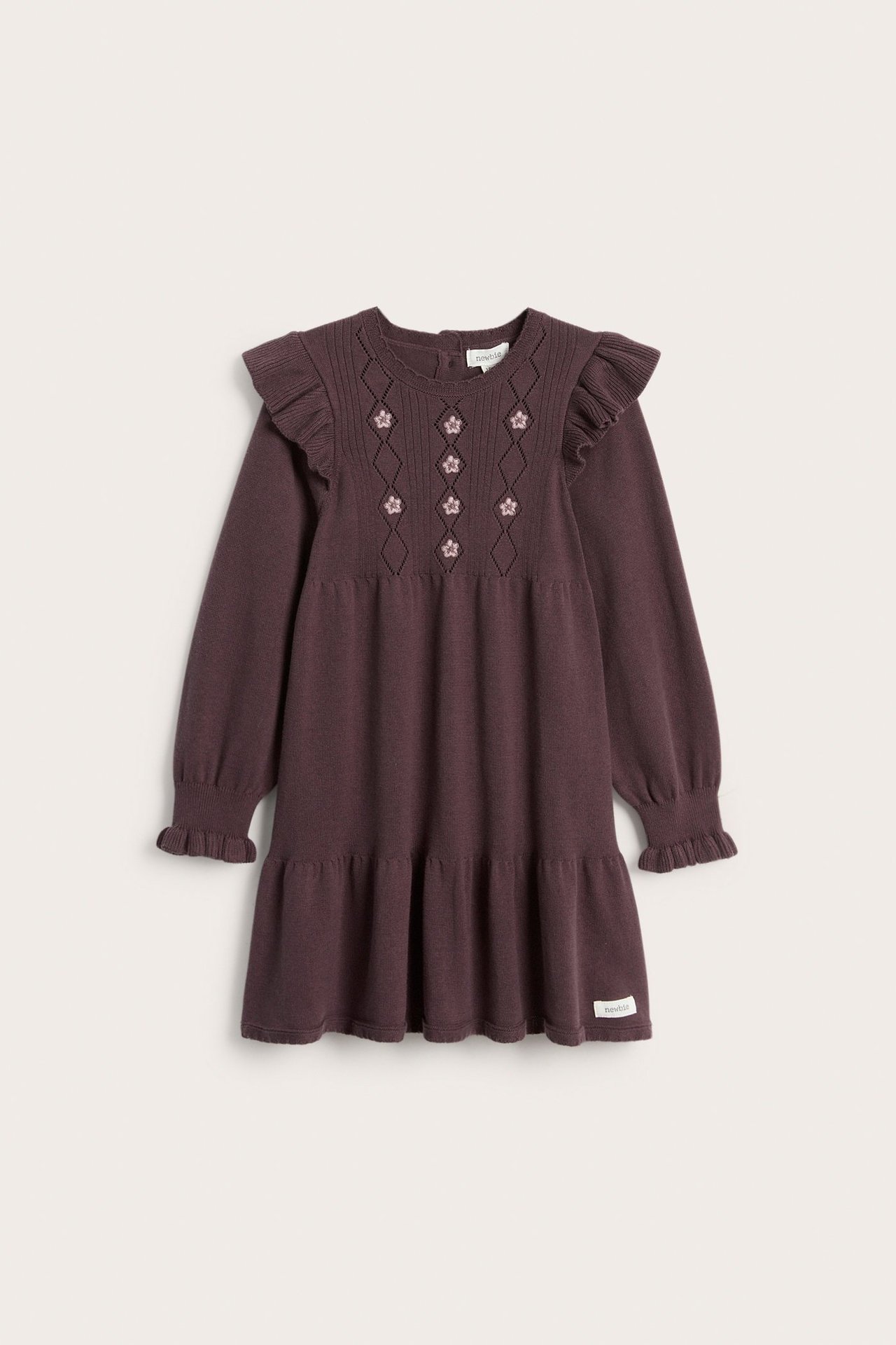 Front view of a kid's dark purple fine-knit cotton dress with ruffled shoulders, floral embroidery, and a tiered hem.