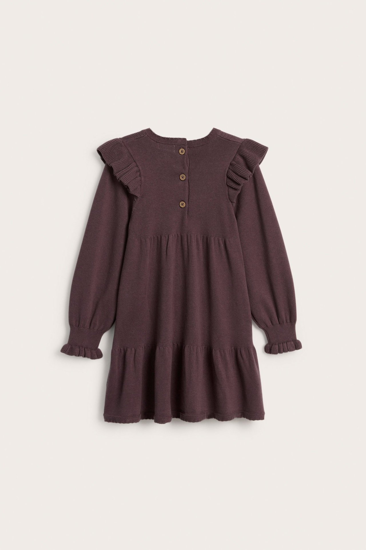 Back view of a kid's lilac fine-knit cotton dress with shoulder ruffles, long sleeves, and back buttons.