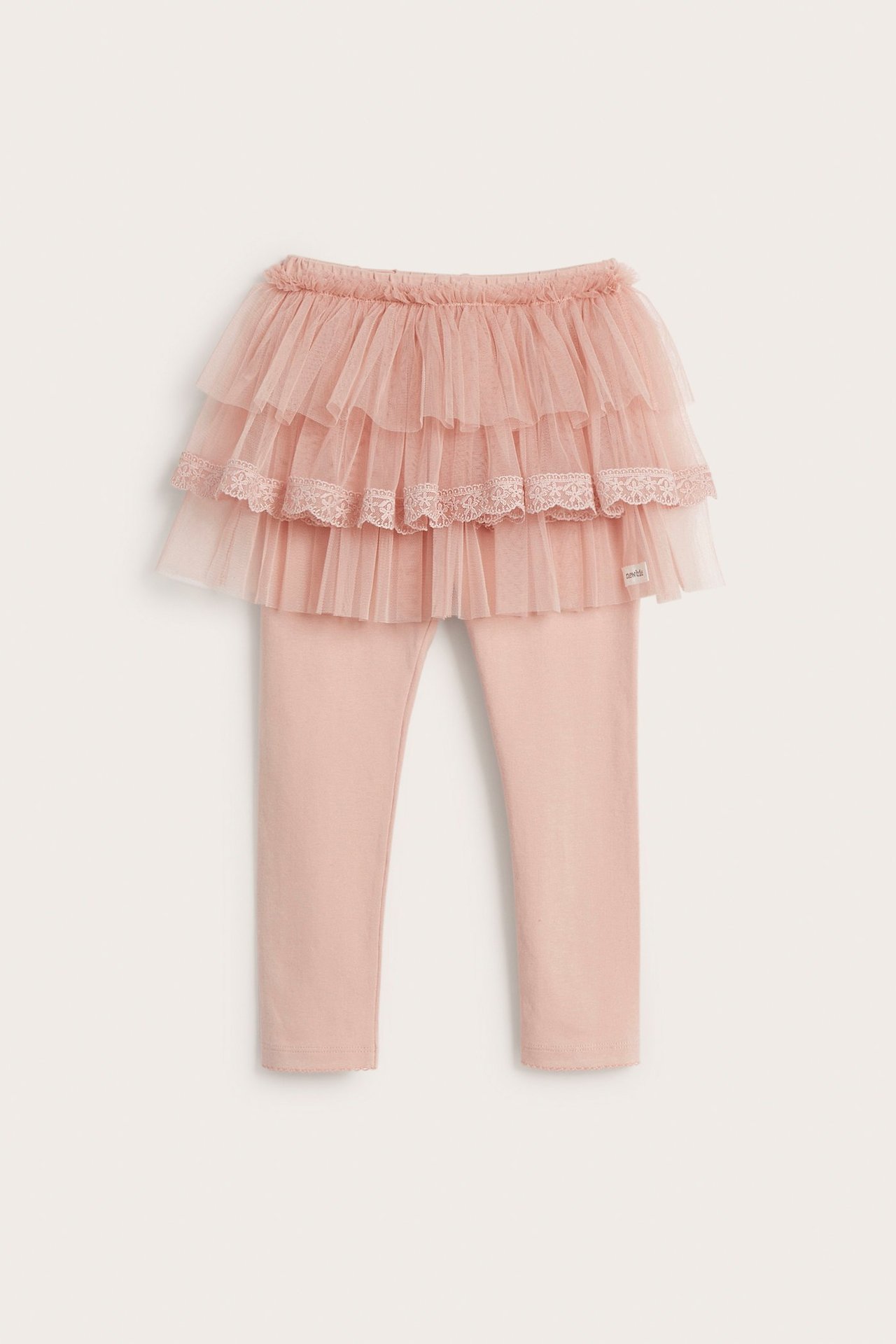 Front view: Kid's pink cotton leggings with attached three-tiered tulle skirt, lace on middle ruffle.