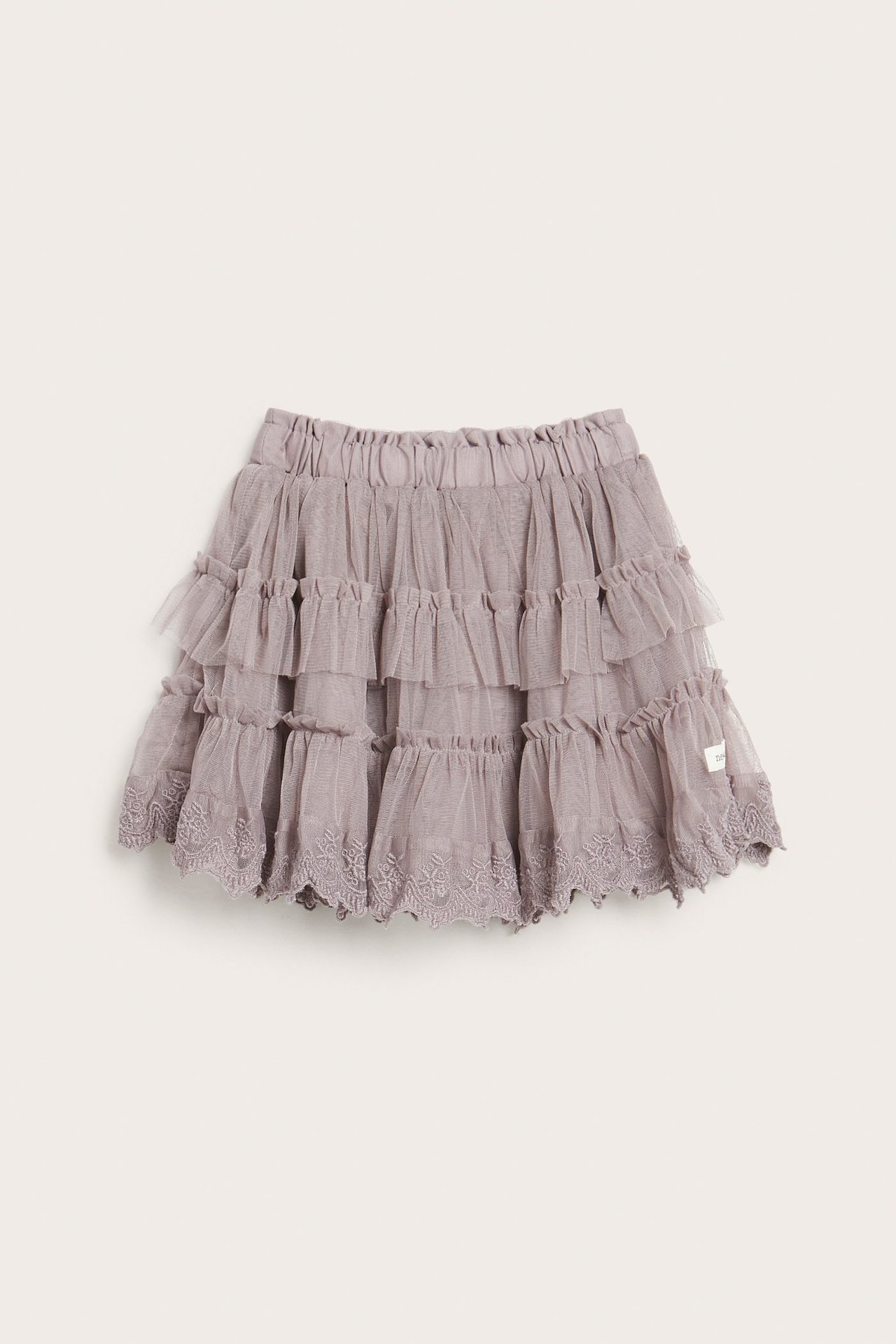 Front view of a kid's light lilac mesh skirt with ruffled tiers and embroidered lace hem, elastic waist.