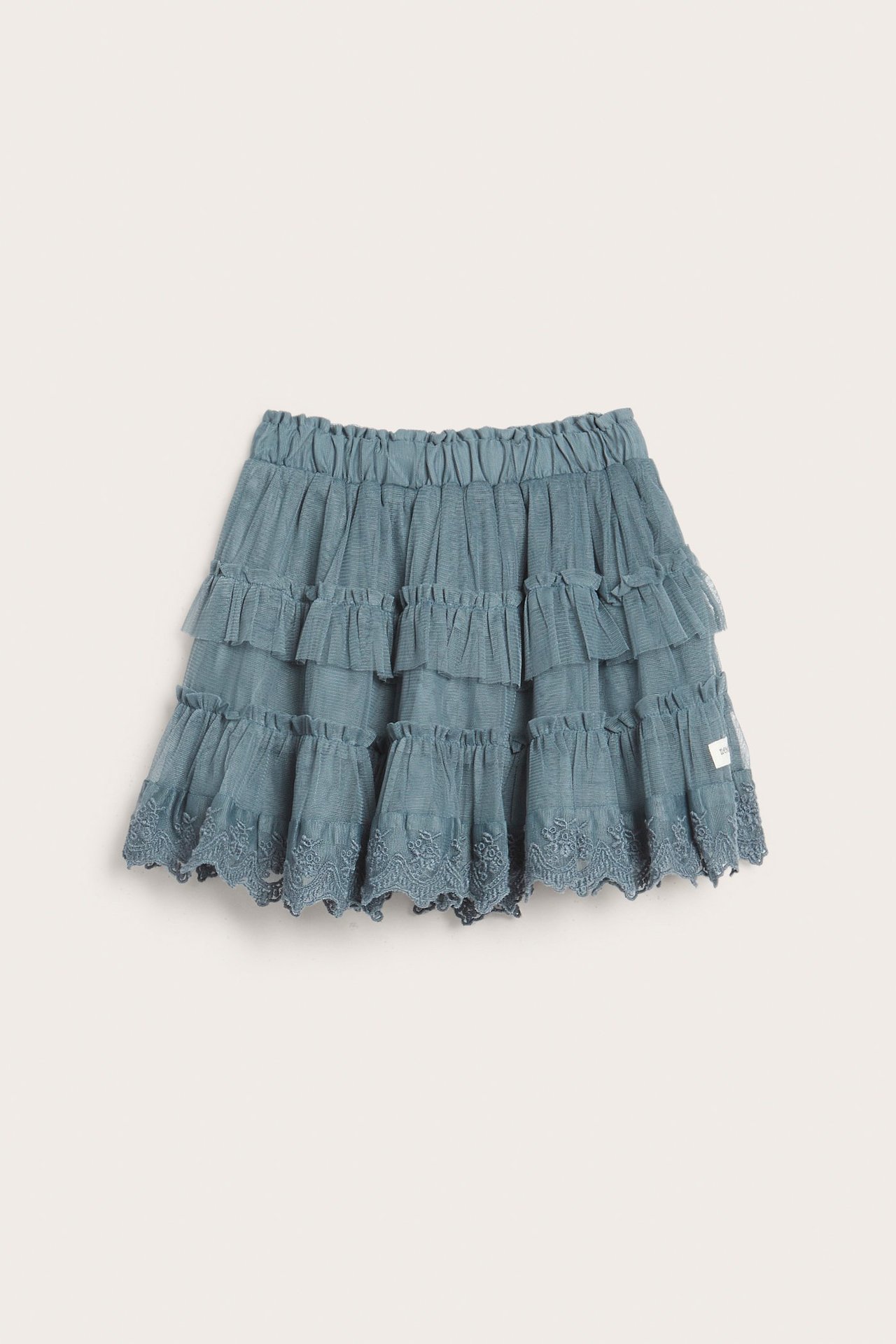 Front view of a kid's blue mesh skirt with tiered ruffles and embroidered lace trim.