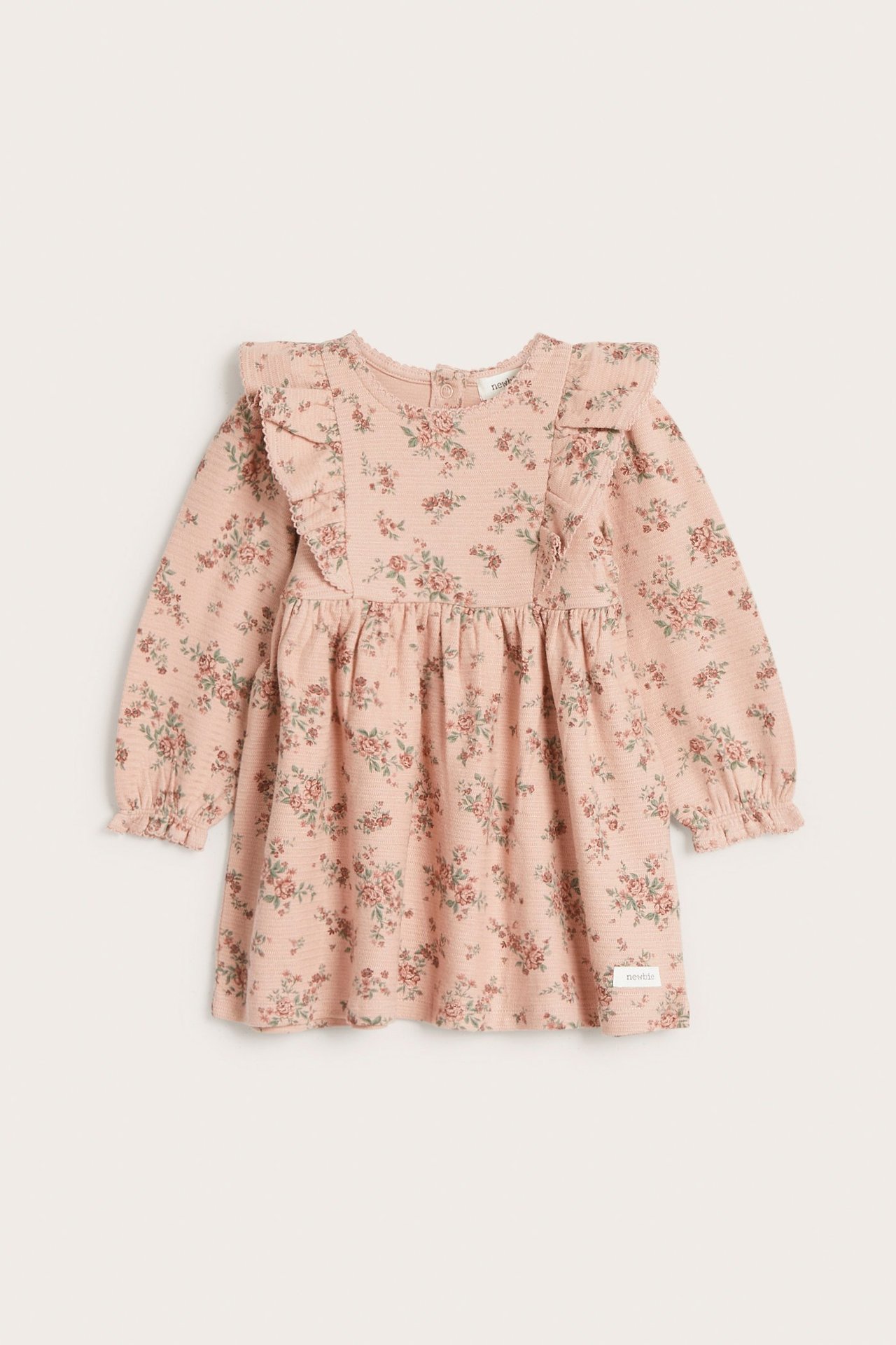 Vorderansicht: Rosa geblümtes Kinderkleid aus Strukturjersey mit langen Ärmeln, elastischen Bündchen und Rüschen.