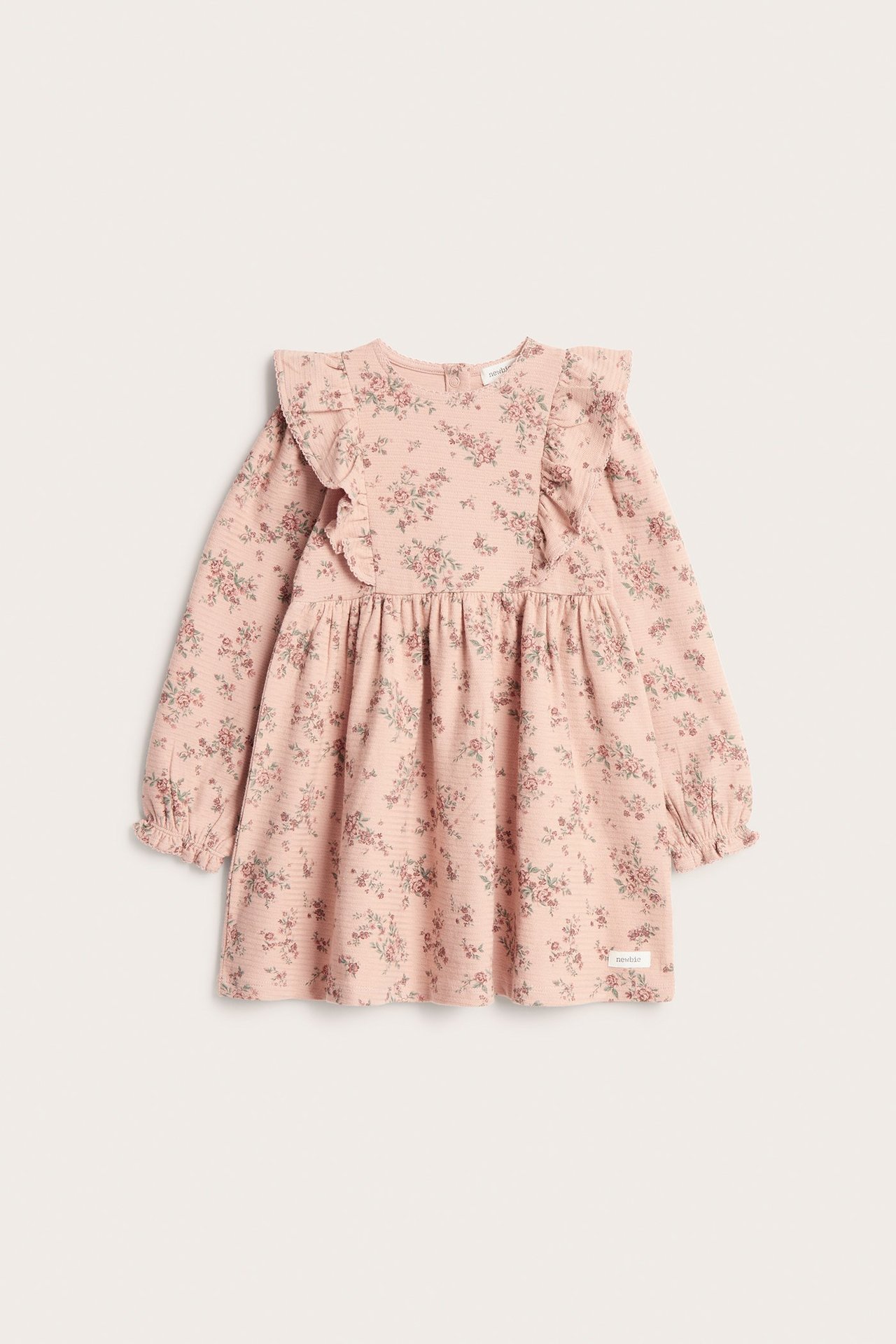 Front view of a pink baby floral dress in structured jersey with ruffles and elastic cuffs.