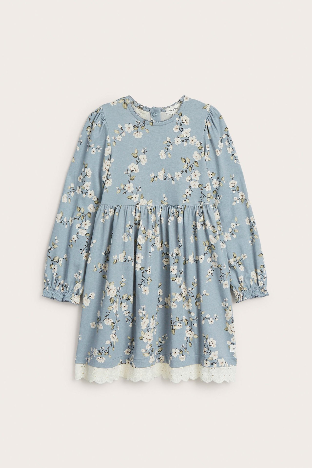 Front view of a light blue floral jersey dress for kids, with puff sleeves and white lace trim.