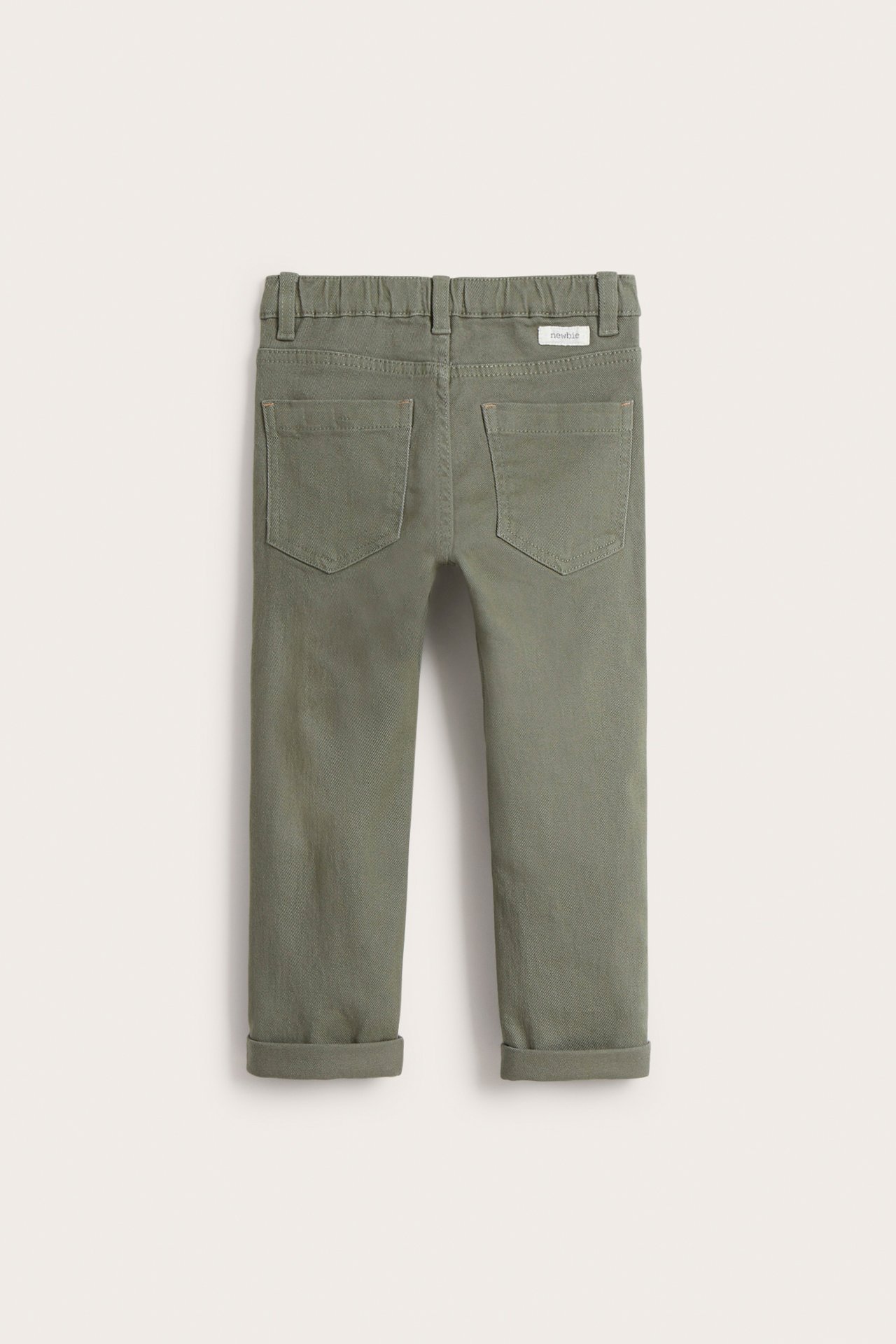 Back view of kid's green woven twill pants with elasticated waist, back pockets, and rolled cuffs.