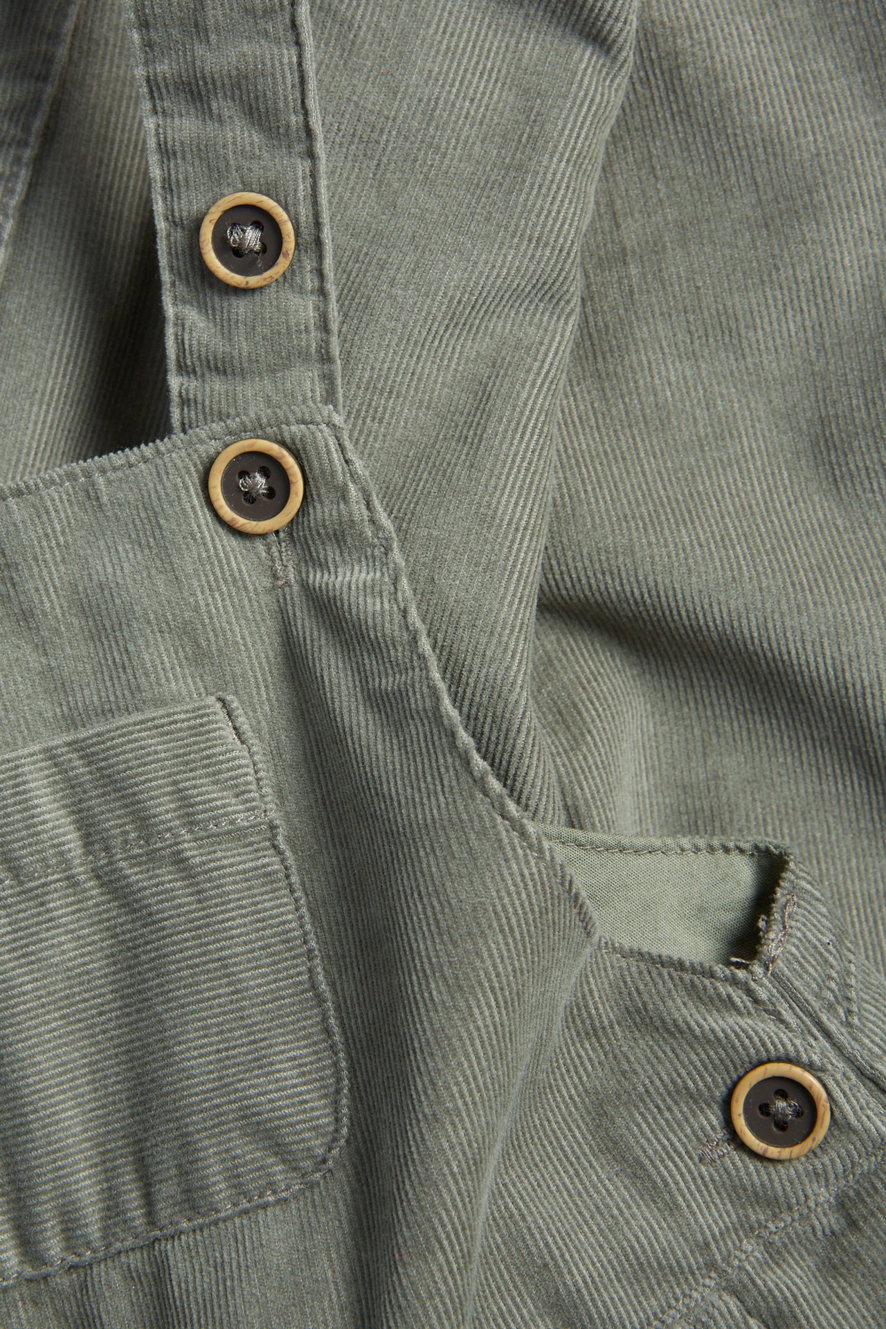 Dunkelgrüne Manchester-Hängselhose für Kind, verstellbare Träger, Knöpfe, Gummizug an den Beinen.