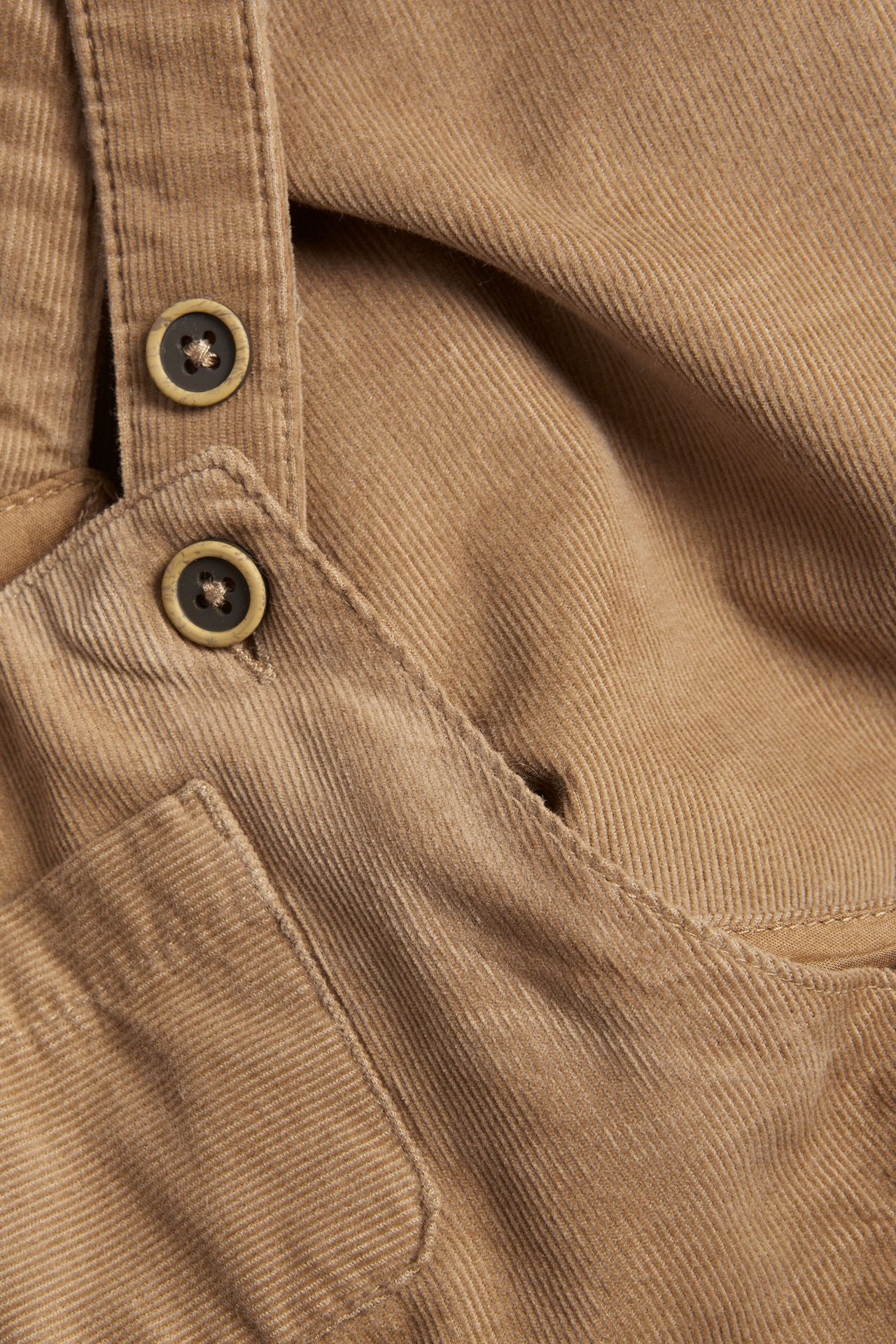Brown Manchester bib pants with adjustable straps, chest pocket, and side pockets.