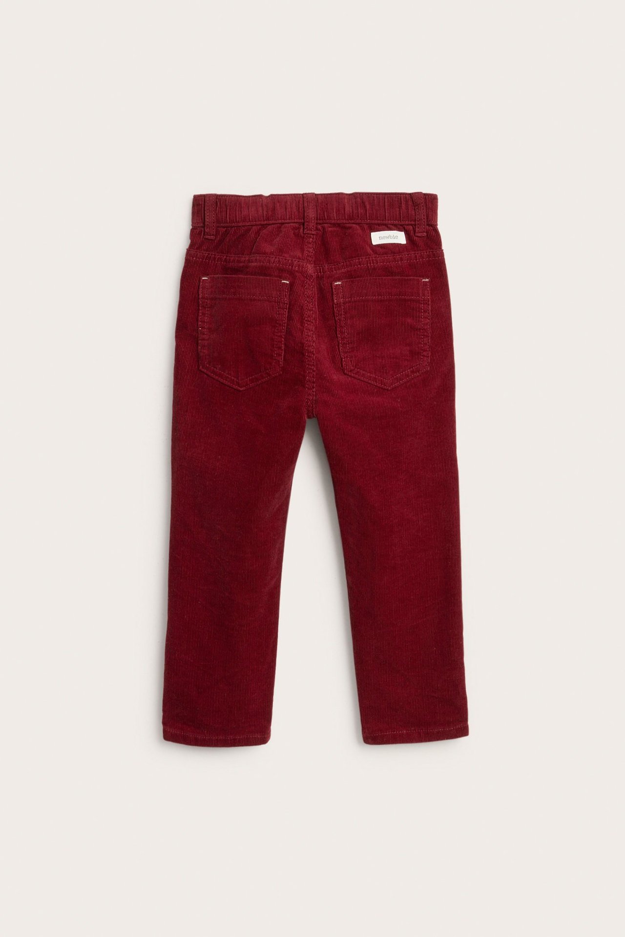 Back view of kid's red corduroy trousers with an elasticated waist and back pockets.