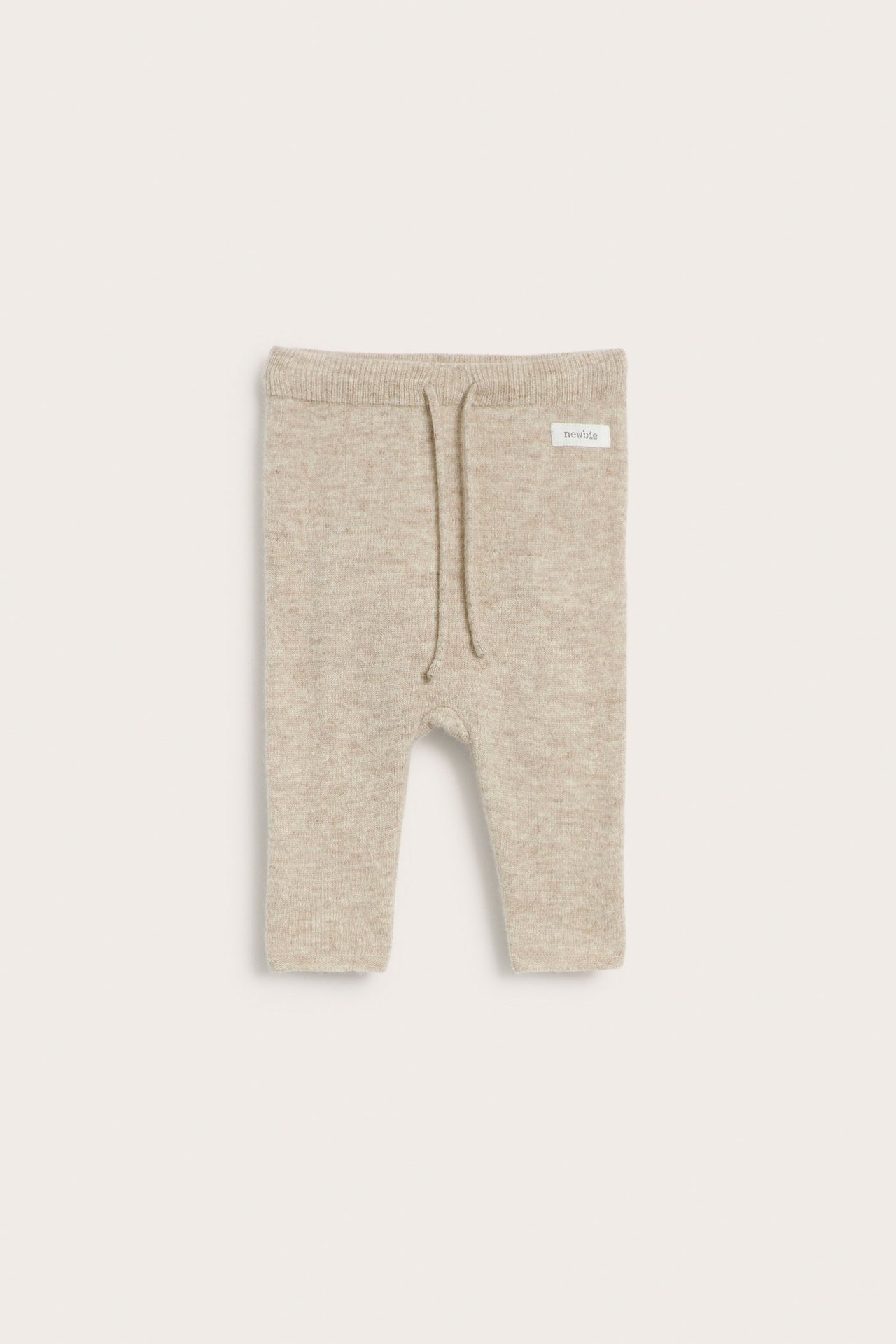 Front view of beige melange baby pants in smooth wool-cashmere knit with elastic drawstring waist.
