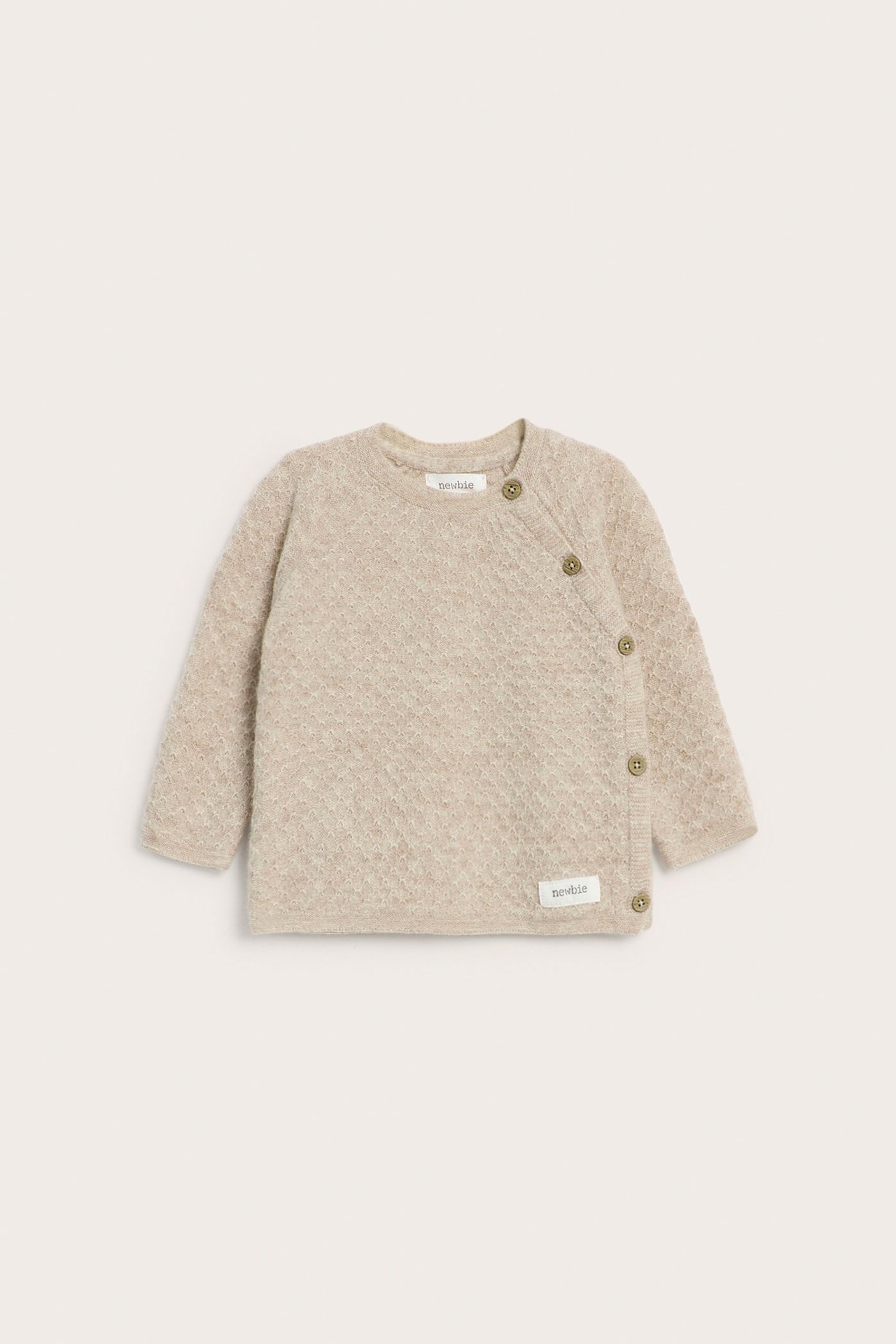 Front view of a beige melange textured knit baby cardigan with side button fastening.