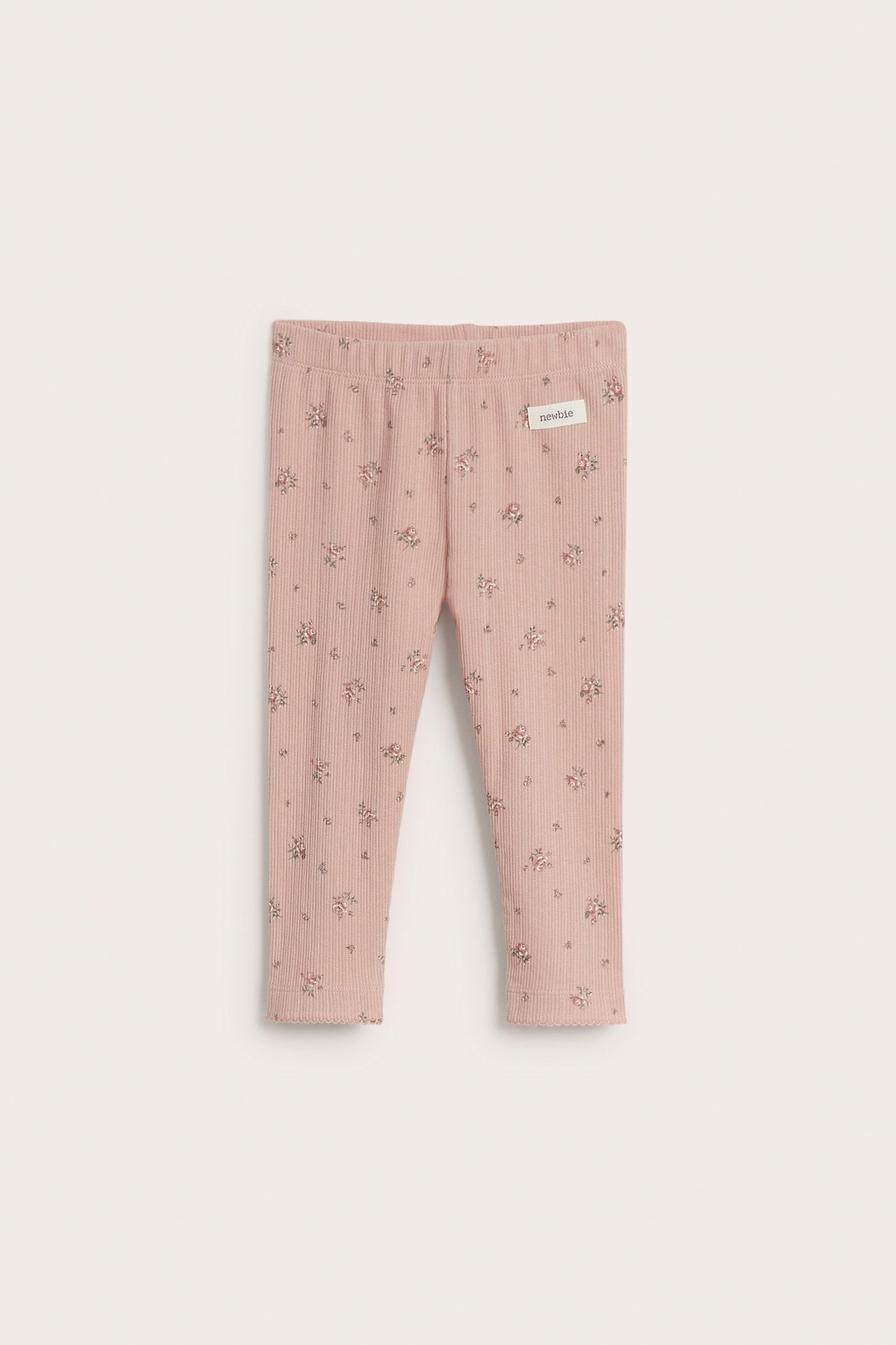 Vorderansicht: Rosa gerippte Baby-Leggings mit Blumenmuster, Gummizugbund und Picot-Saum.