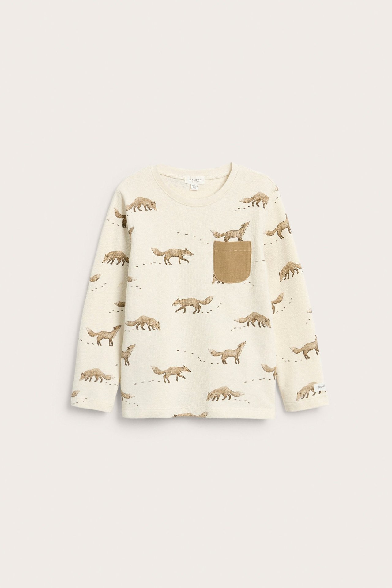 Vorderansicht: Hellbeiges Kinder-Langarmshirt aus Strukturbaumwolle mit Fuchsmuster und brauner Brusttasche.