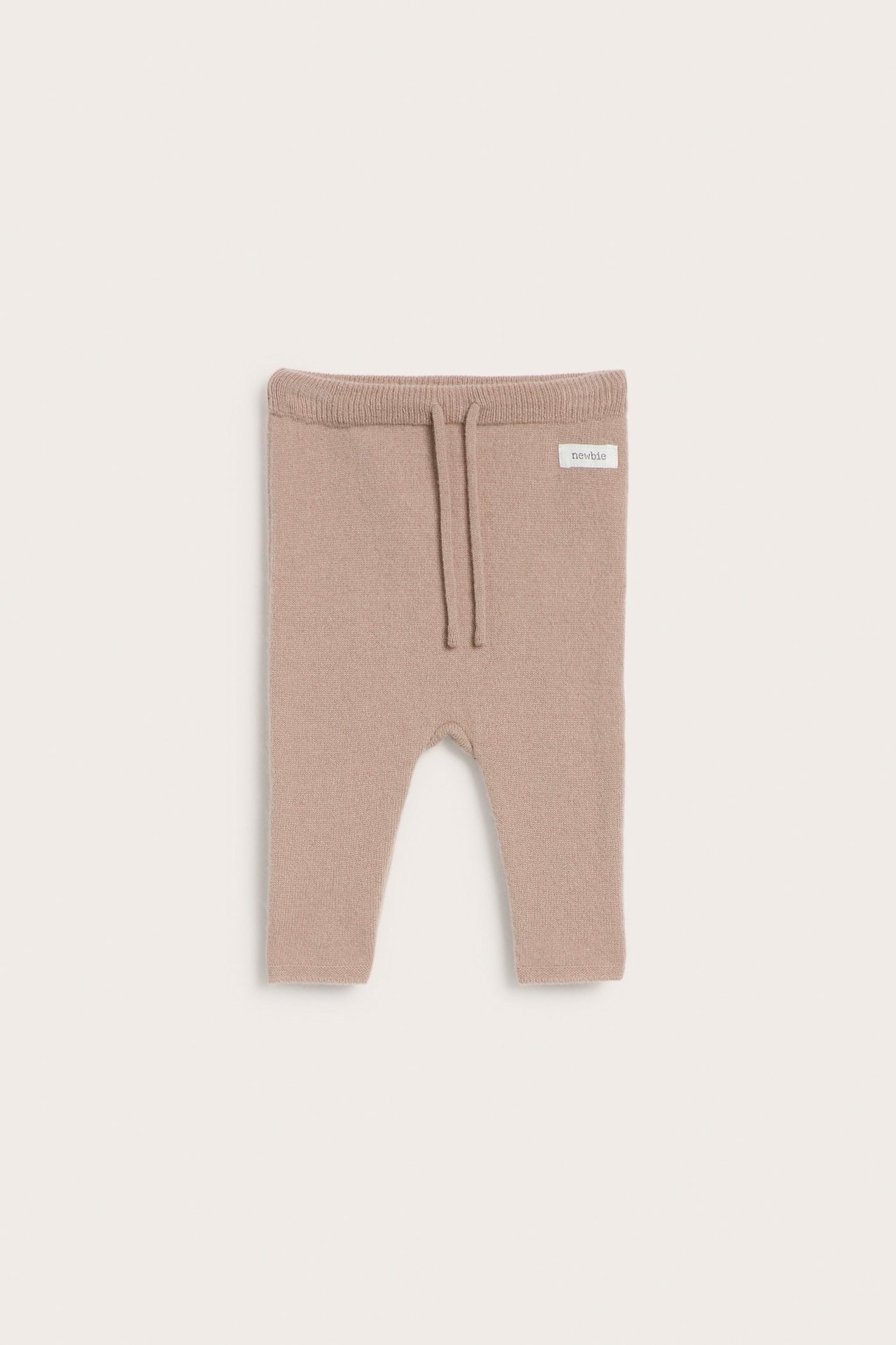 Front view of baby's dusty pink plain knit wool and cashmere blend pants with a drawstring waist.