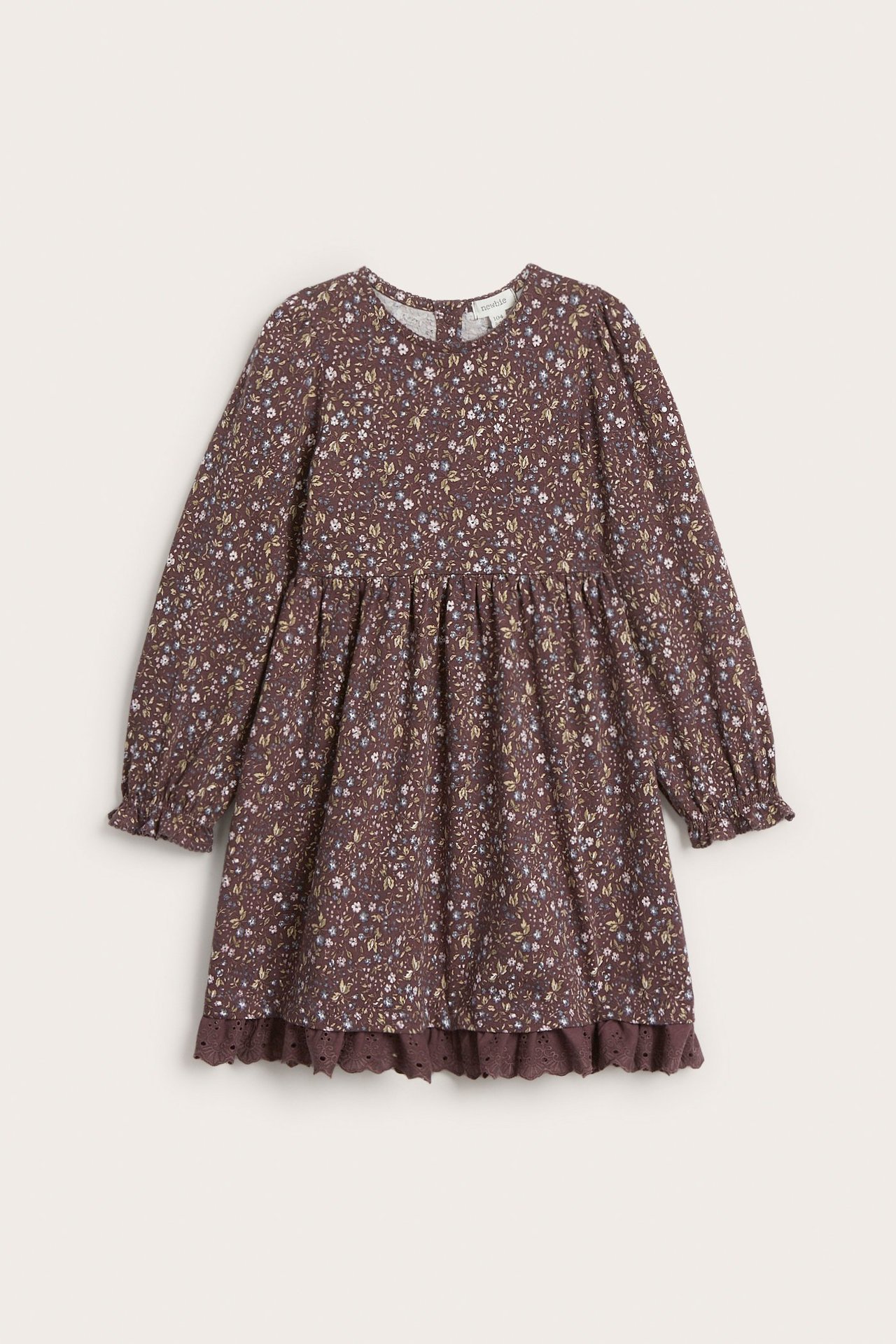 Front view of a kid's dark lilac floral jersey dress with puff sleeves and a lace-trimmed hem.