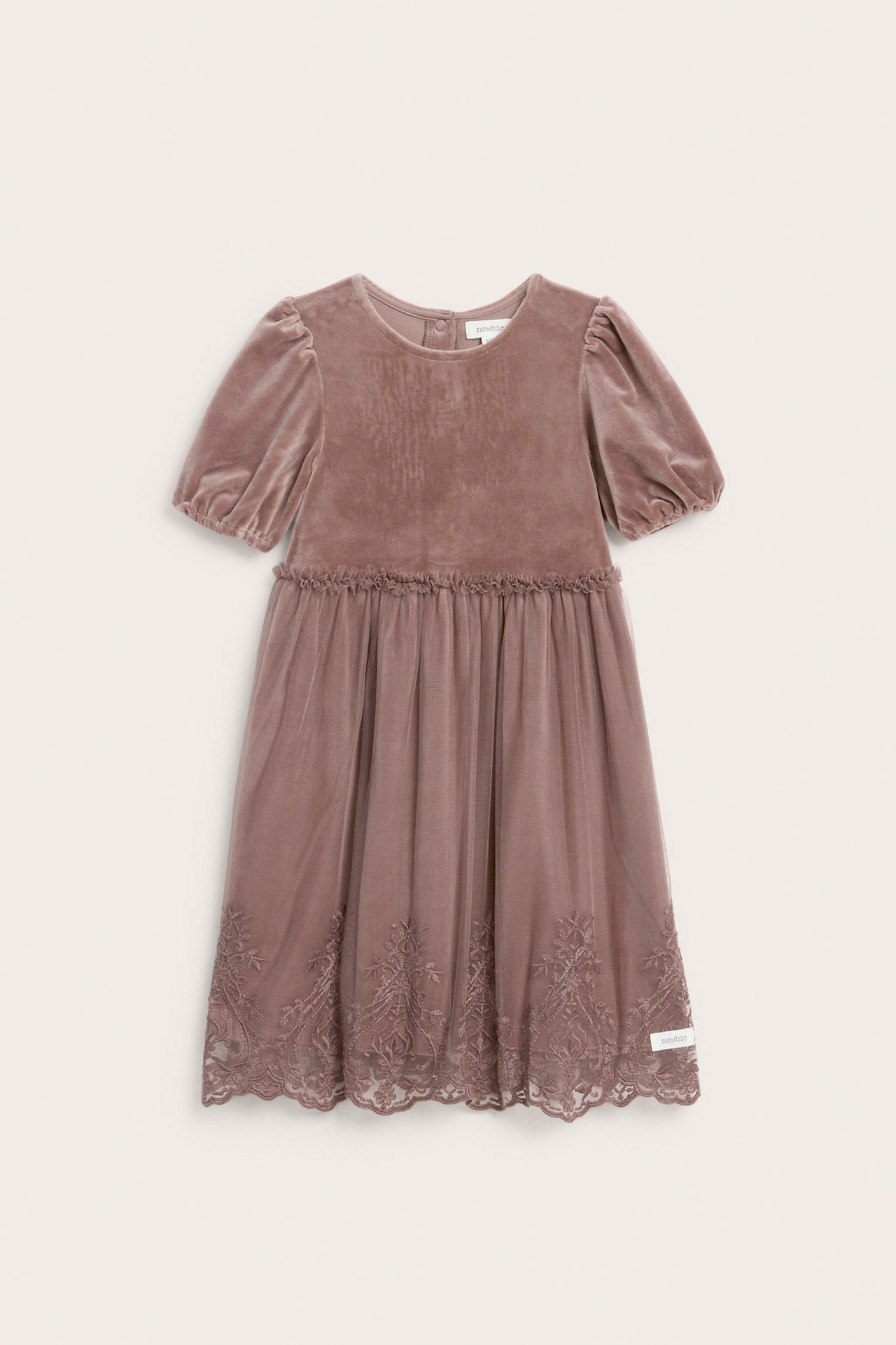 Front view of a kid's dark pink velour dress with puff sleeves and an embroidered mesh skirt.