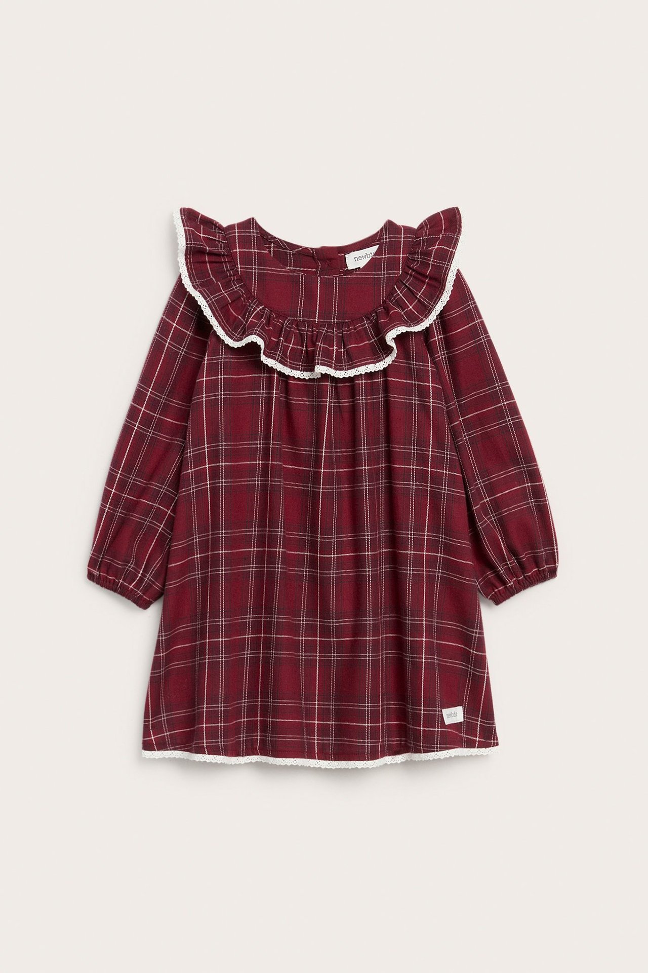 Front view of a kid's red plaid cotton dress with a rounded ruffle collar and white lace trim.