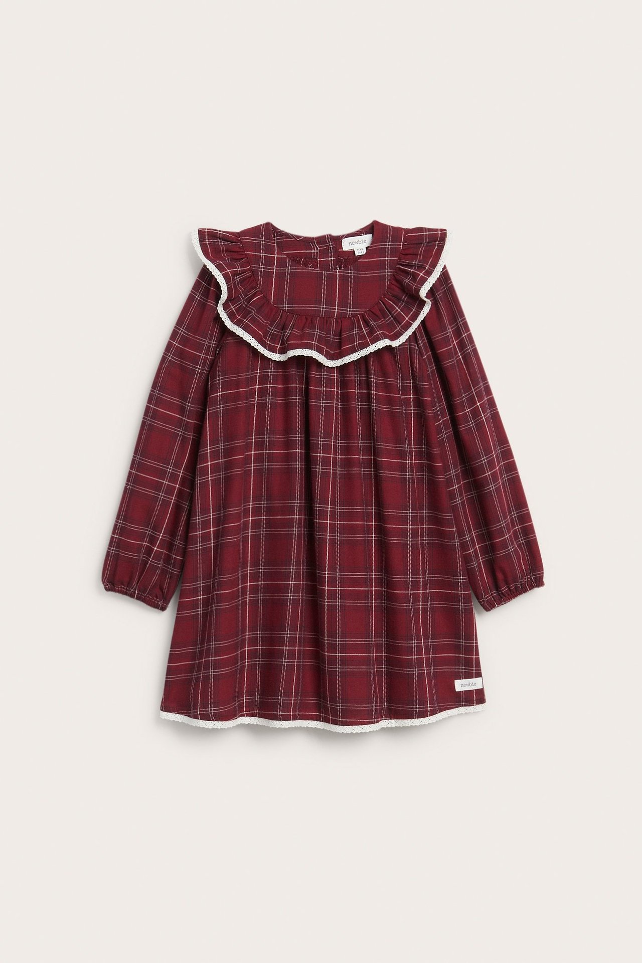 Front view of a kid's red plaid cotton dress with a rounded ruffle collar and white lace trim.