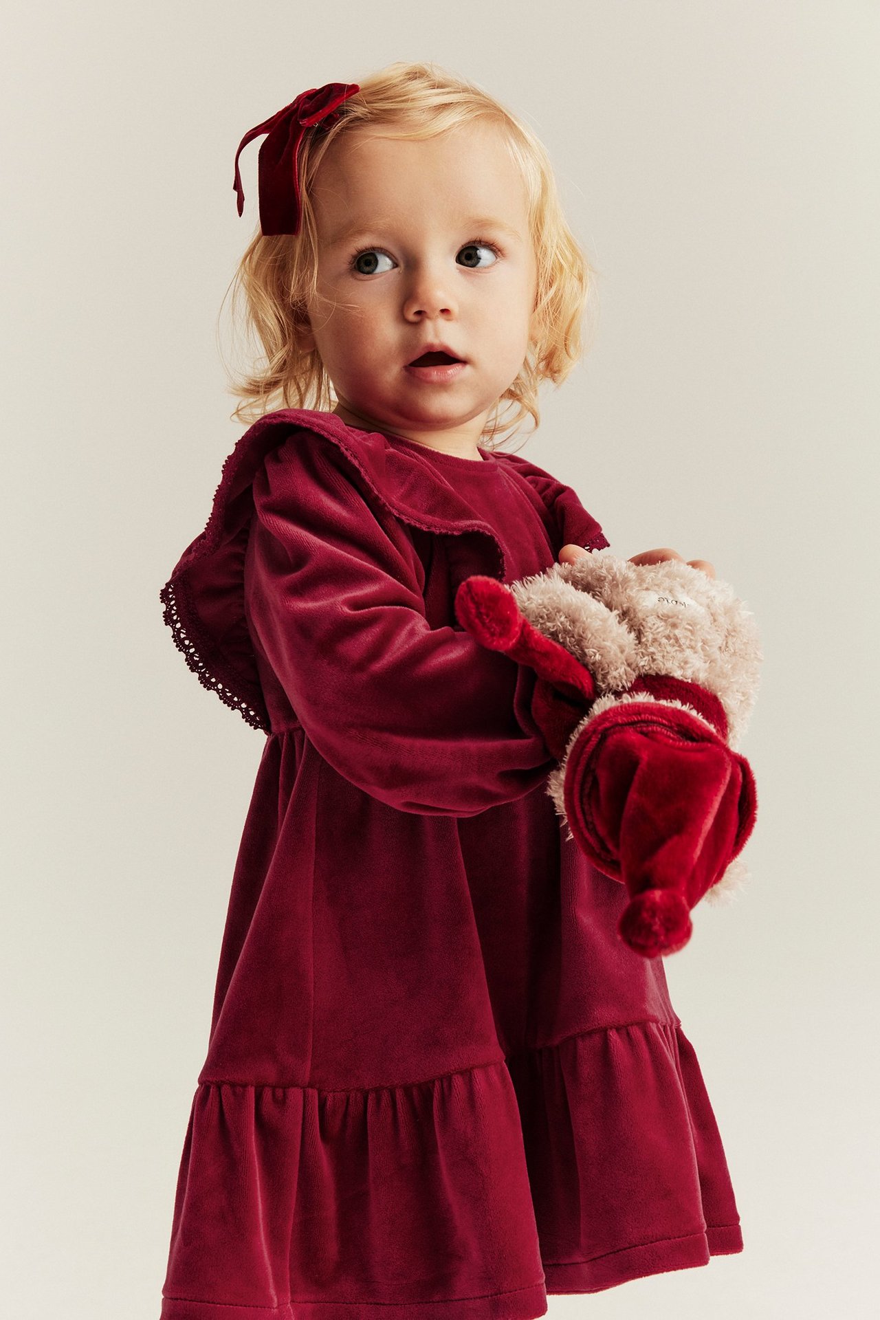 Red velour dress in recycled polyester with ruffles, lace trim, elastic, back buttons.