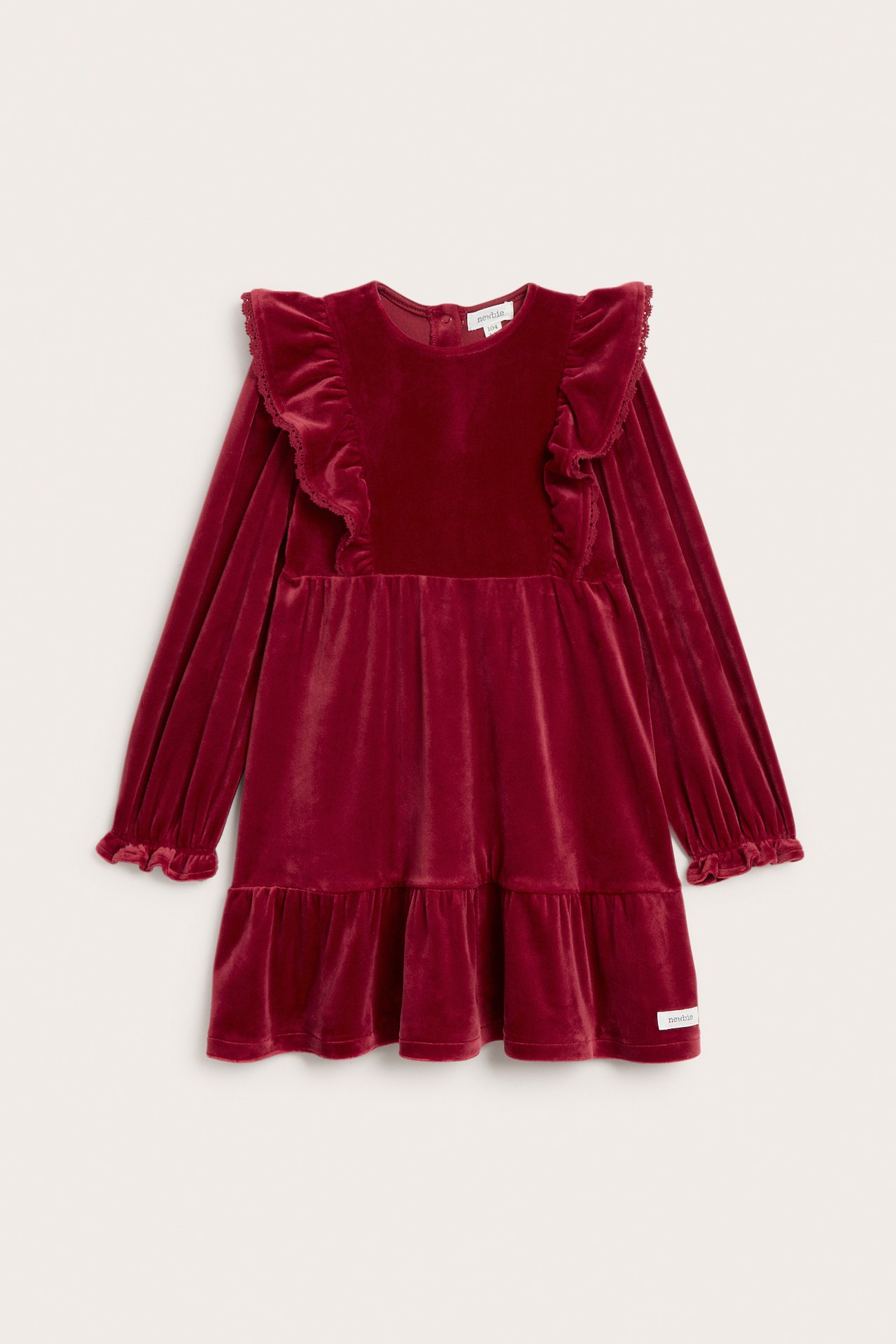 Front view of a kid's red velour dress with ruffled shoulders, long sleeves, and a tiered skirt.