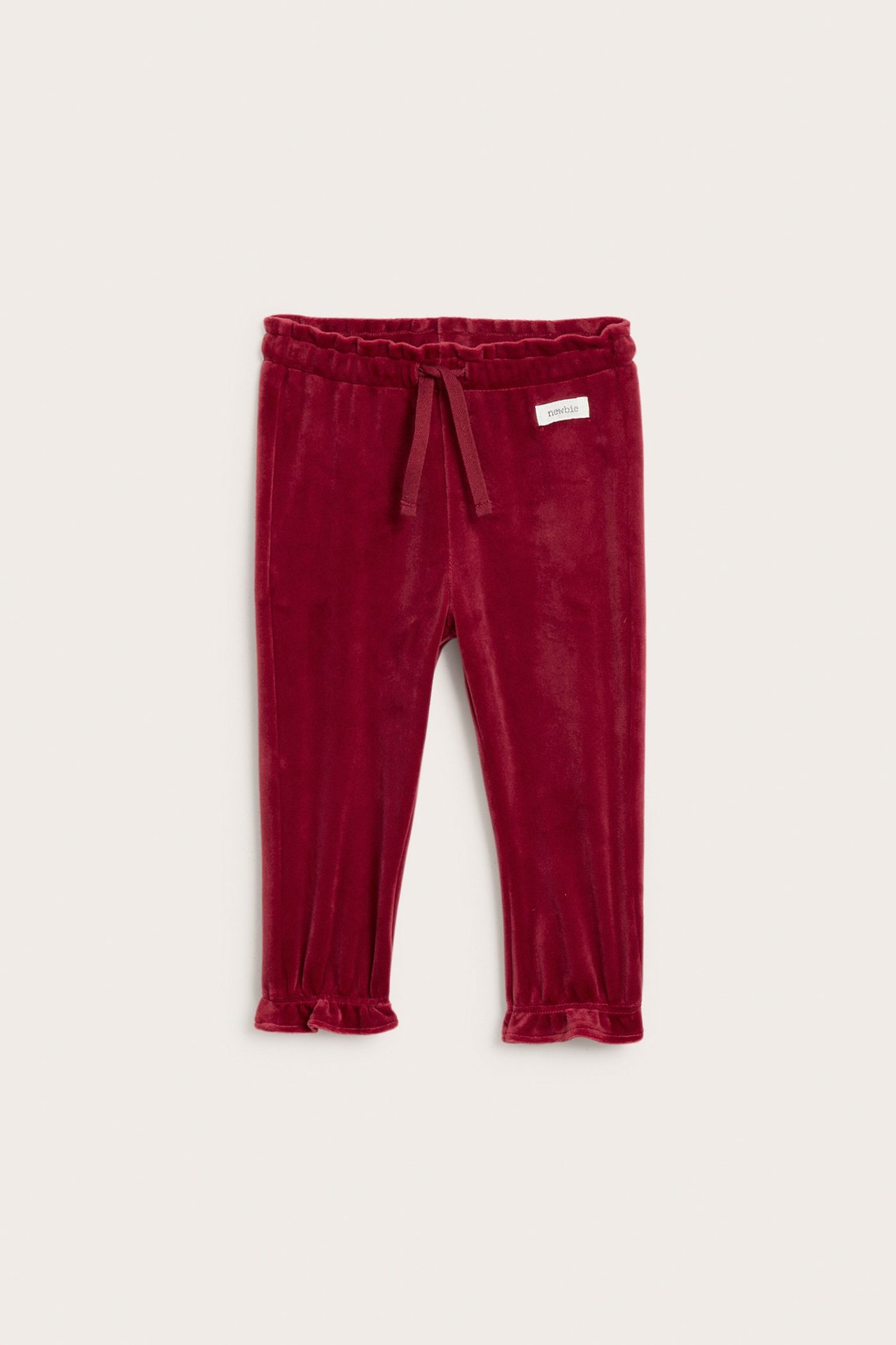 Front view of solid red velour baby jogging pants with elastic waist and ruffled cuffs.