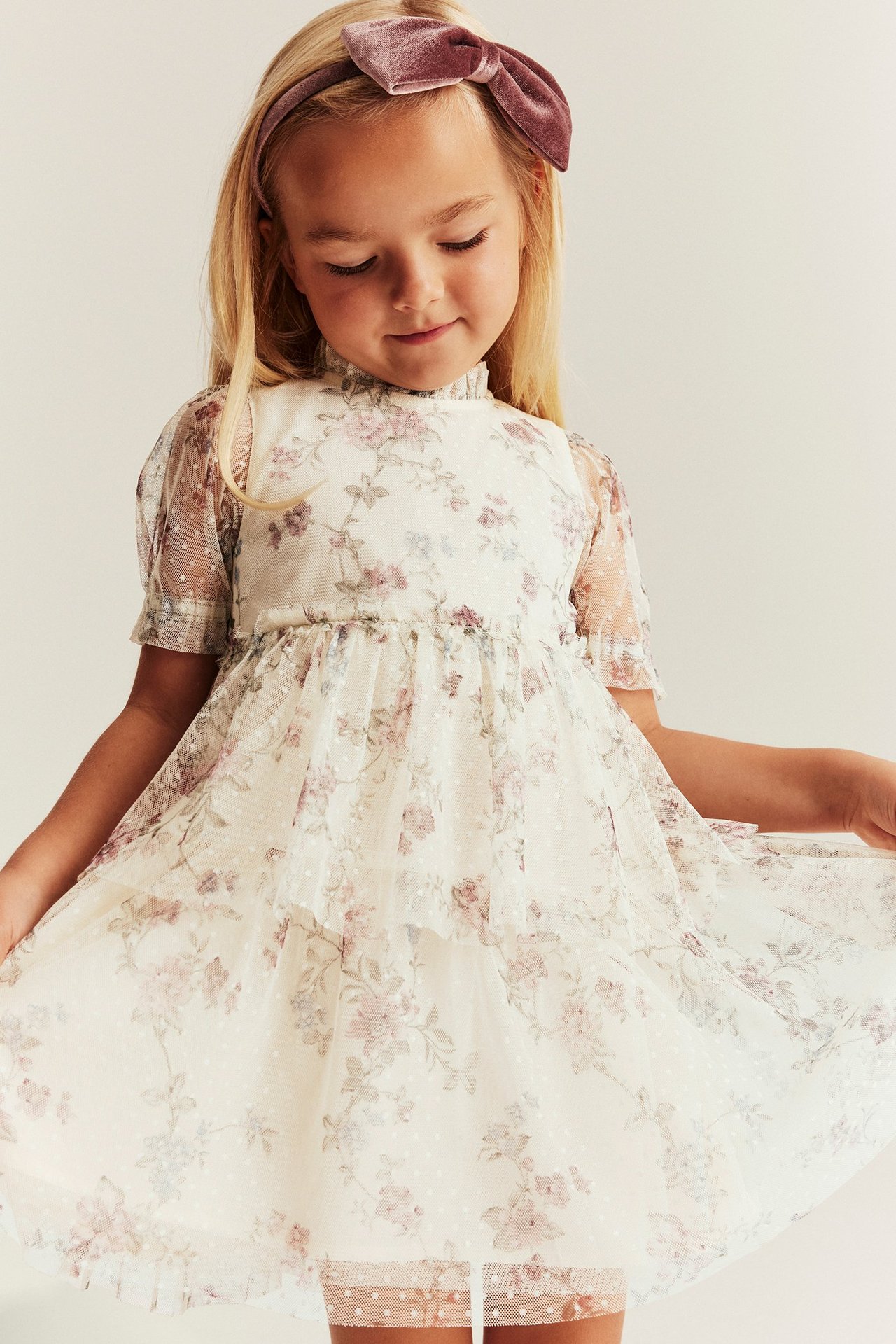 Light beige floral mesh dress for kid with ruffled skirt and puff sleeves.