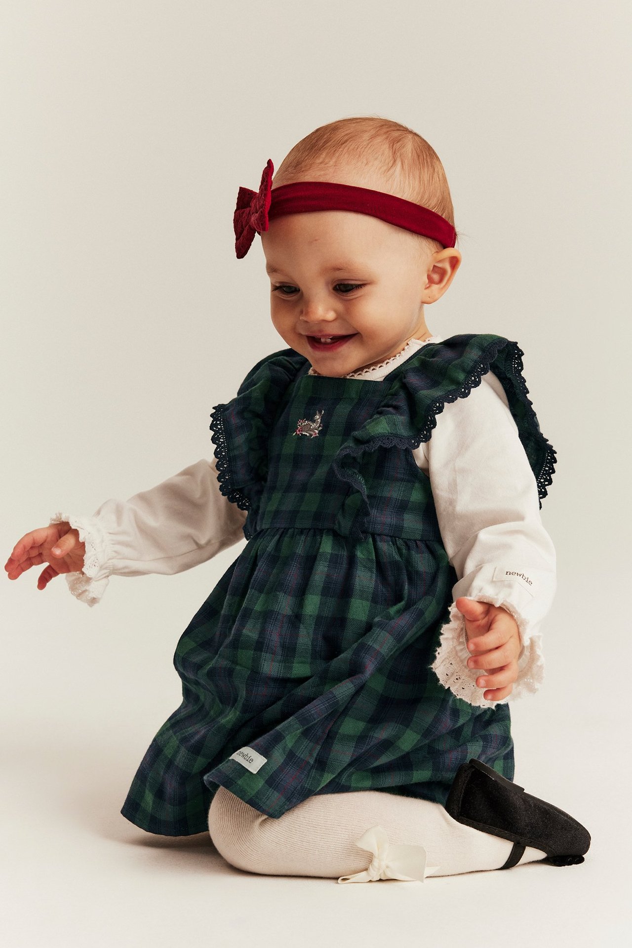 Blue plaid overall dress with embroidery, ruffled lace edges, back buttons, for young girl.
