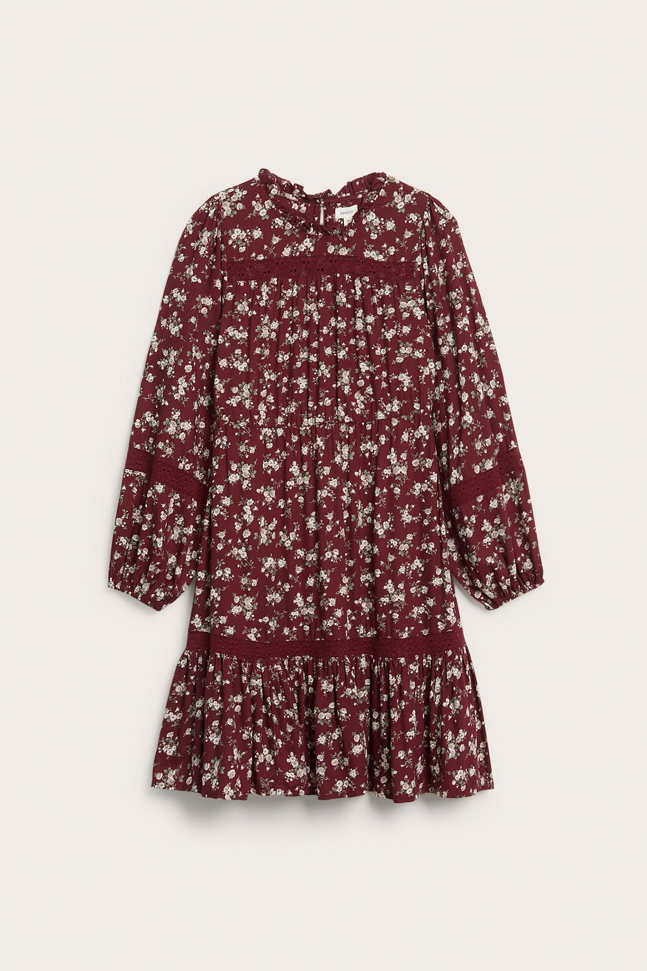 Front view of a red floral knee-length viscose dress with long sleeves, ruffle collar, and lace inserts.