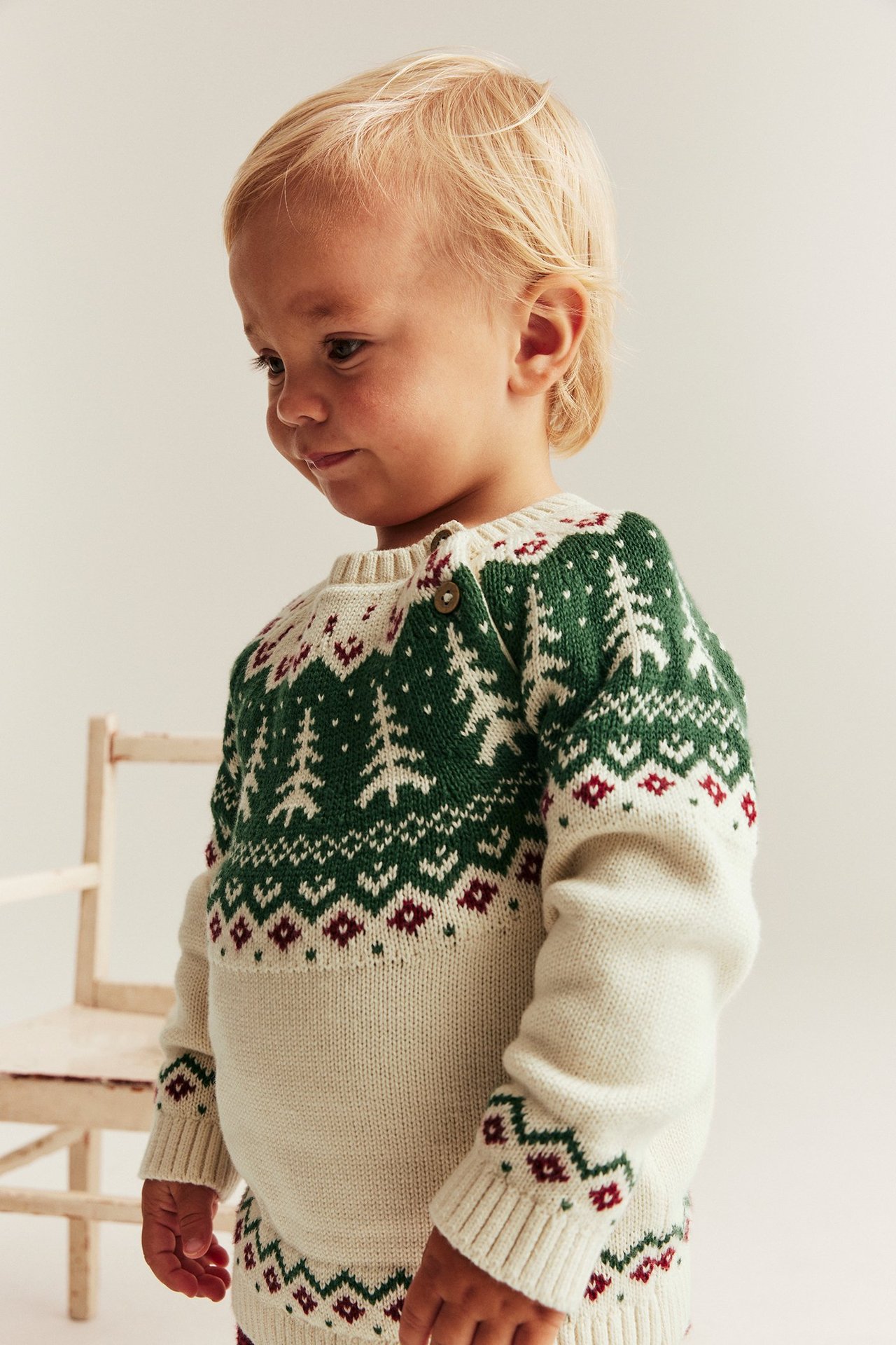 Knitted Christmas sweater with spruce trees