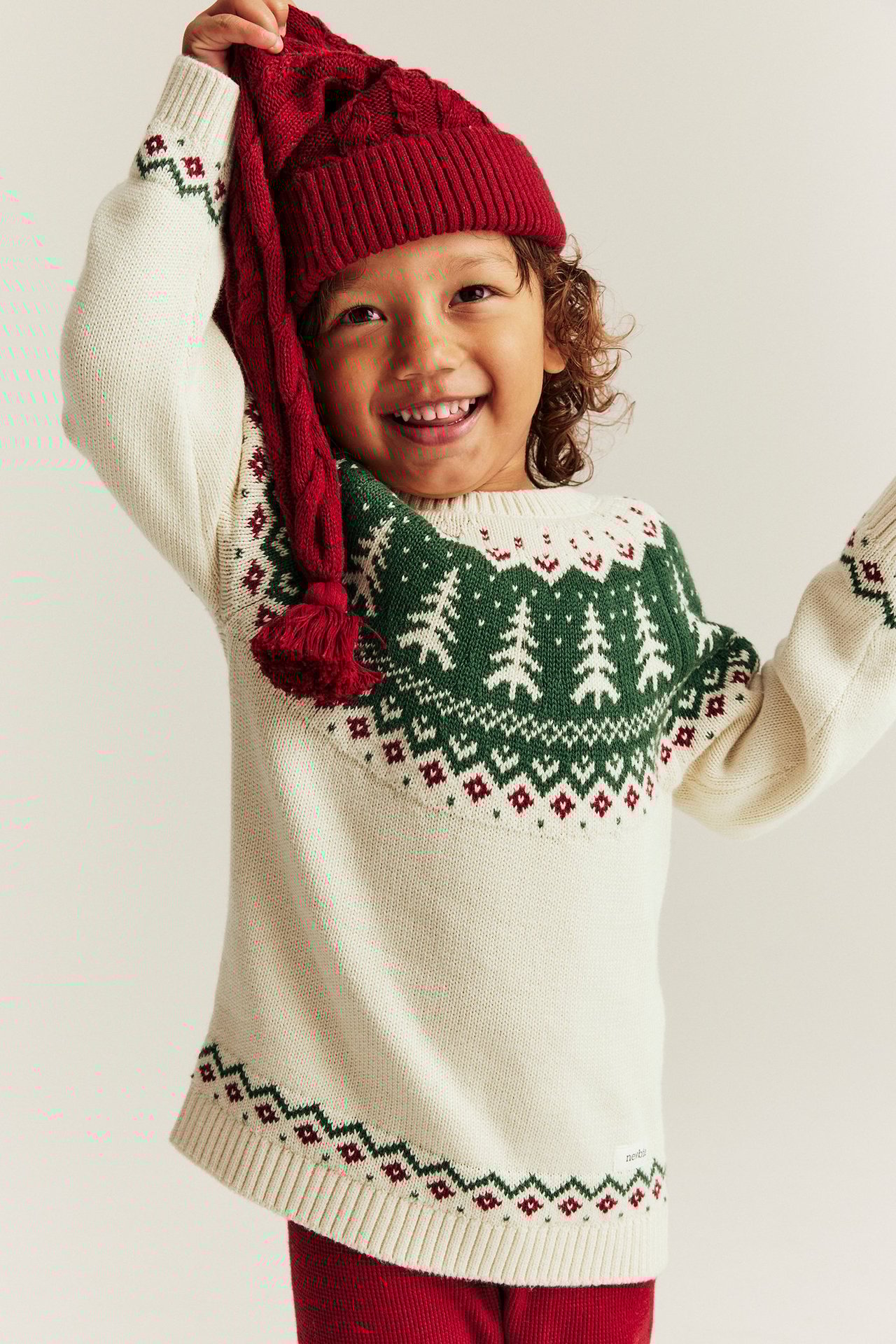 Knitted Christmas sweater with spruce trees