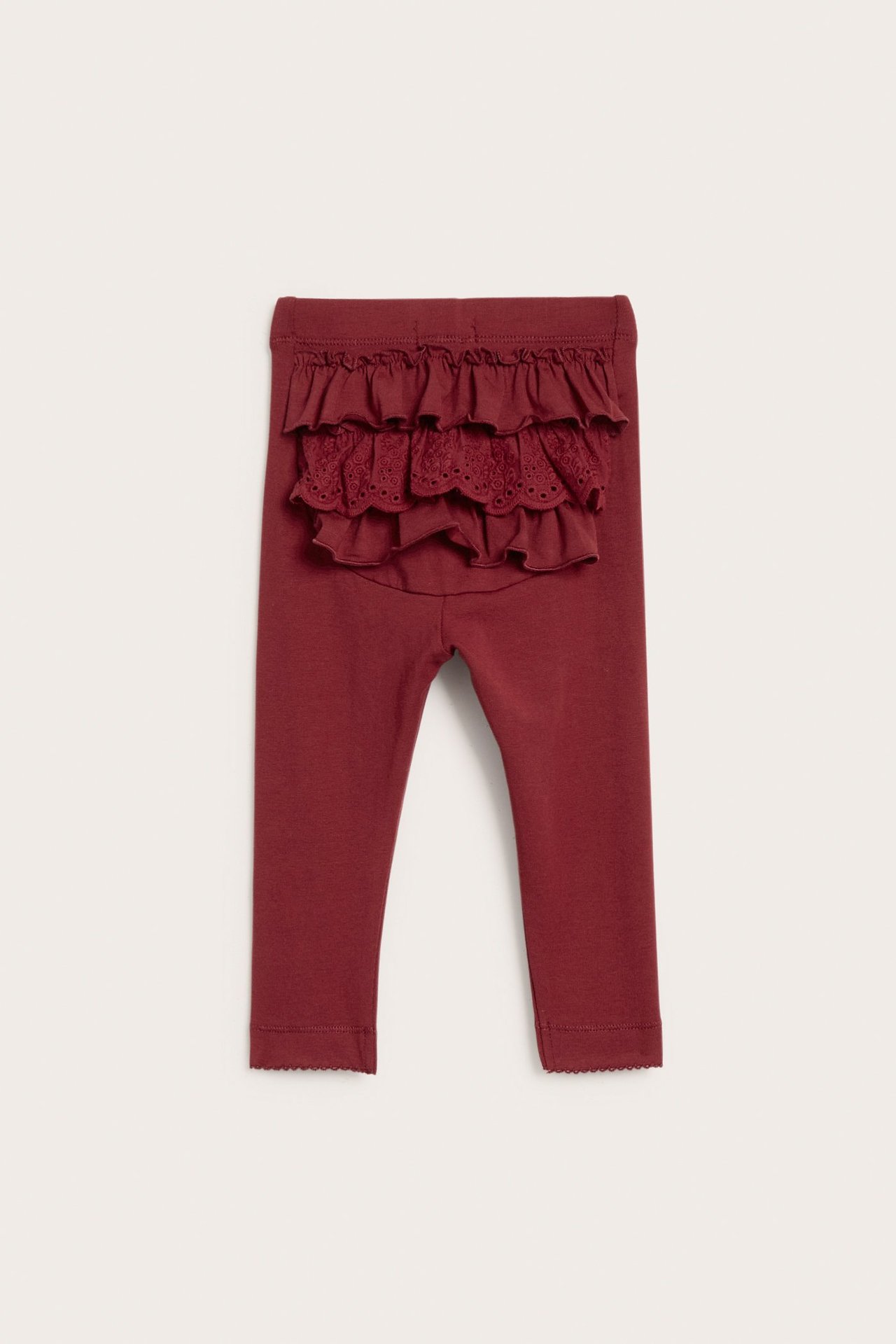 Rückansicht: Rote Baby-Leggings aus Baumwollmischung mit Gummibund und Spitzenrüschen.