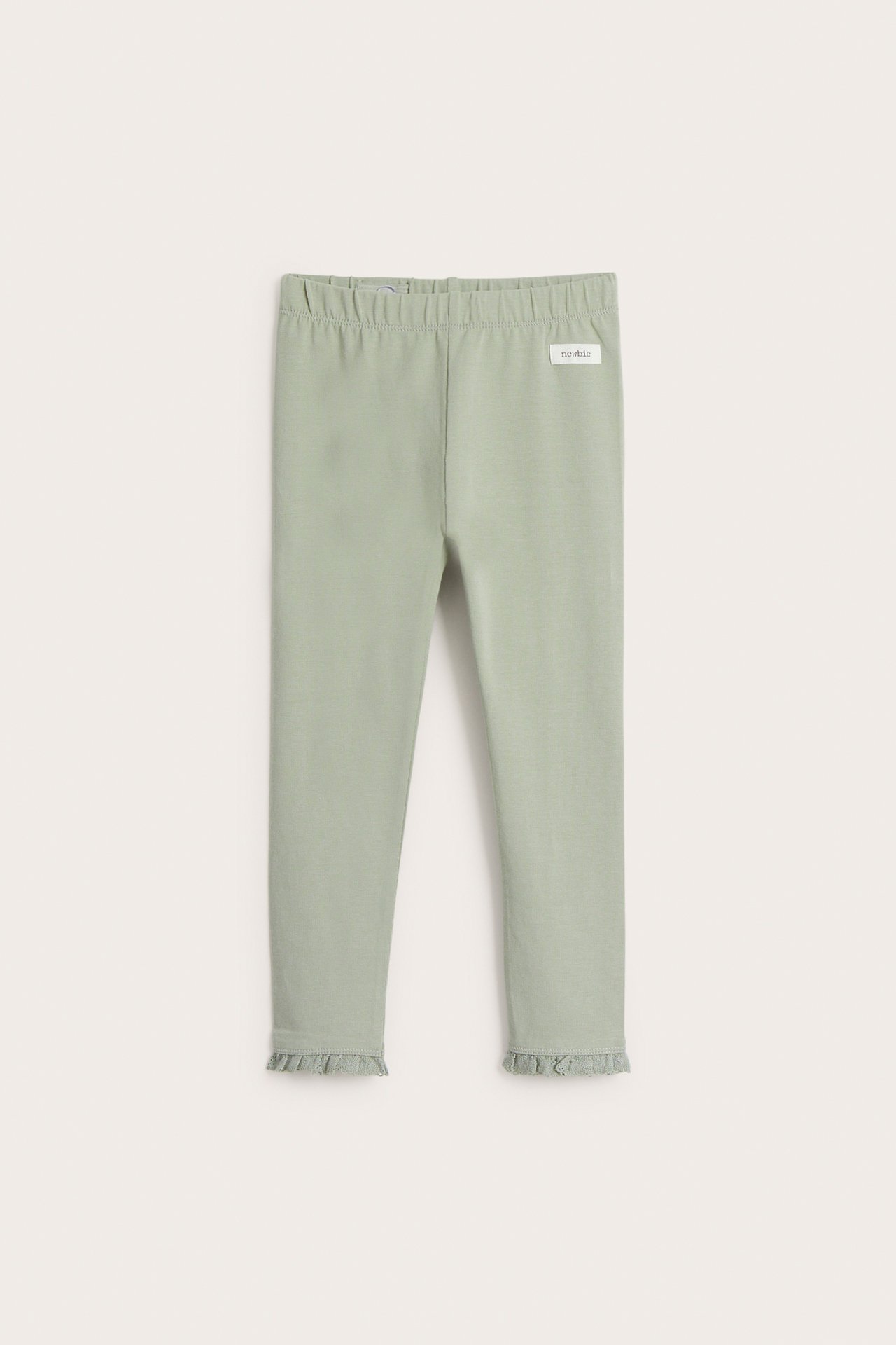 Front view: Light green baby cotton leggings with elasticated waist and lace ruffles at ankles.