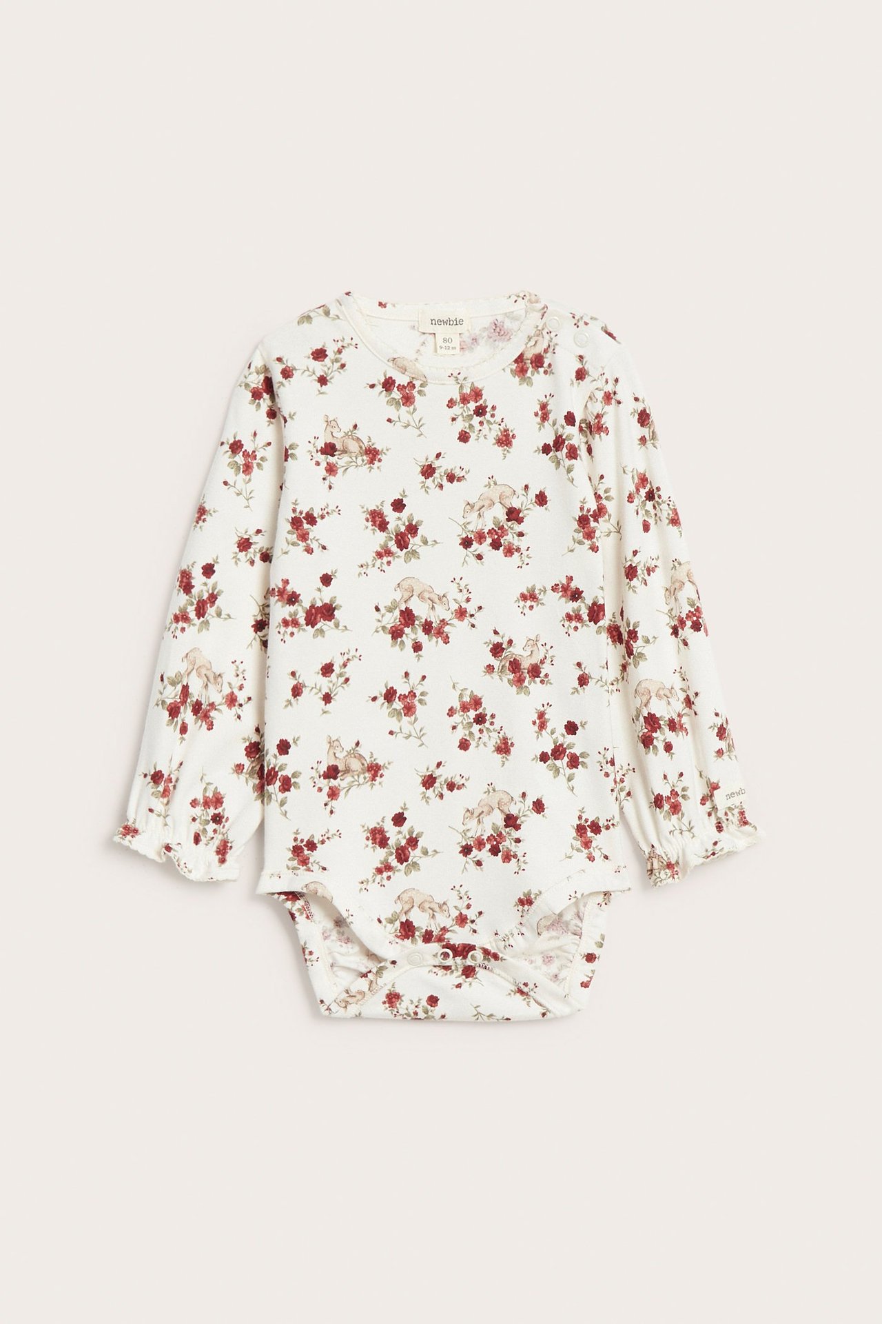 Front view of an off-white baby long-sleeved bodysuit with red floral and bunny print, picot trim, and ruffled cuffs.